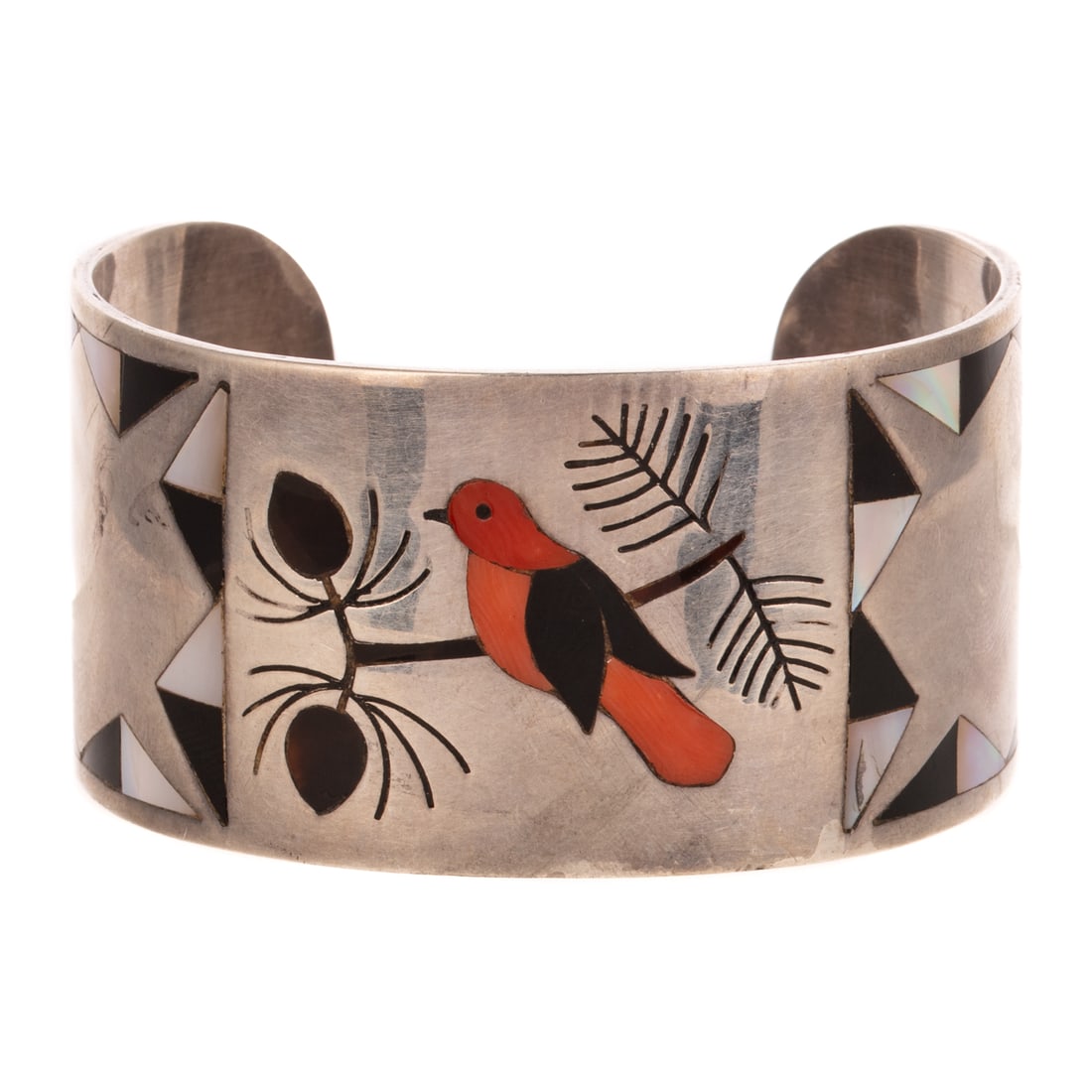 A Signed Zuni Cardinal Inlay Cuff in Sterling Silver: c.1970s, Sterling silver cuff bracelet attributed to Zuni artist Albert & Dolly Banteah, designed with black onyx, Mother of Pearl, and coral in a central cardinal design with triangles on the edge, 2