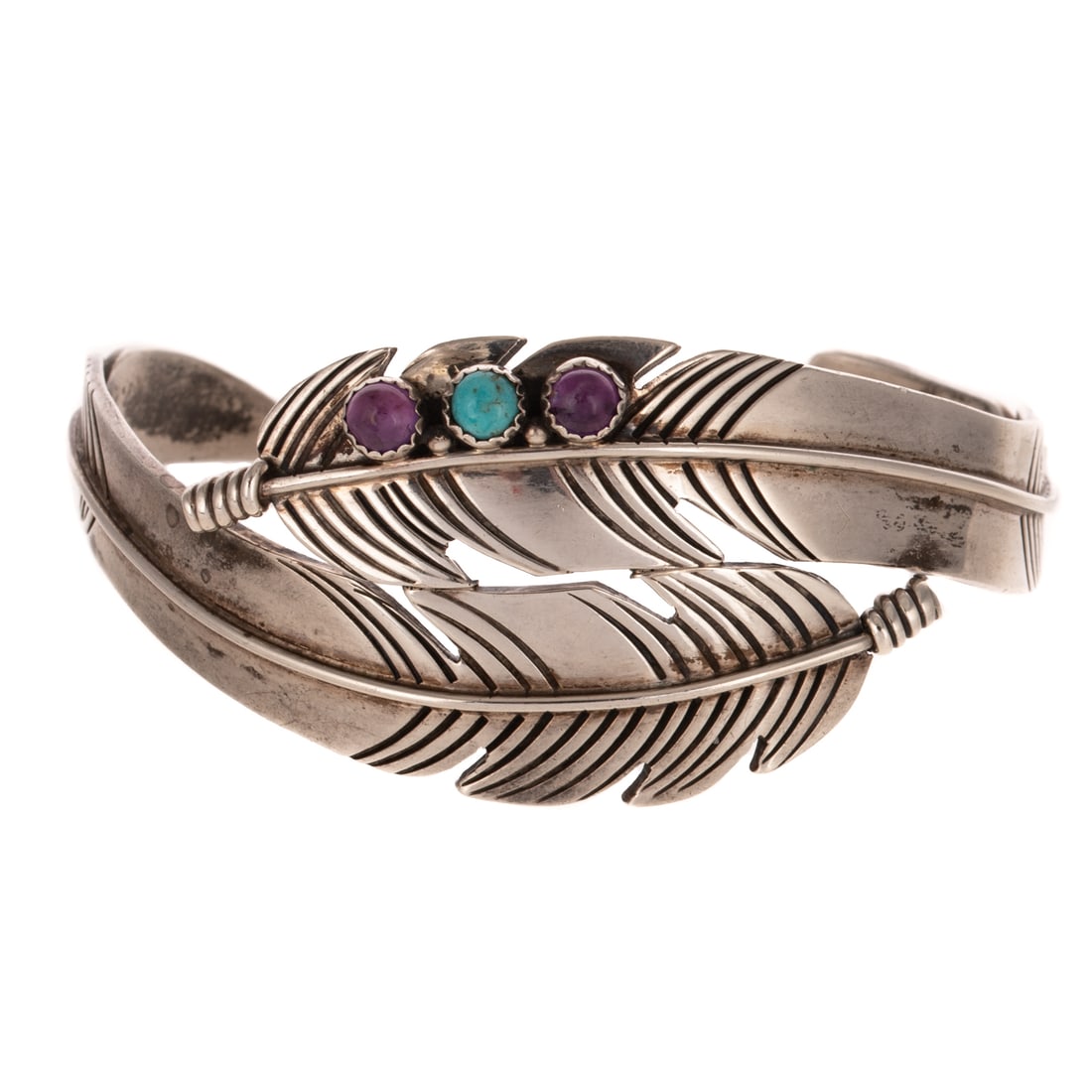 A D'Anz Feather Cuff Bracelet in Sterling Silver: Sterling silver cuff bracelet by D'Anz, Albuquerque designed with bypassing feathers with bezel set amethyst and turquoise, 2 1/4 interior Diam. signed, 25.6 grams Provenance: From a private collectio