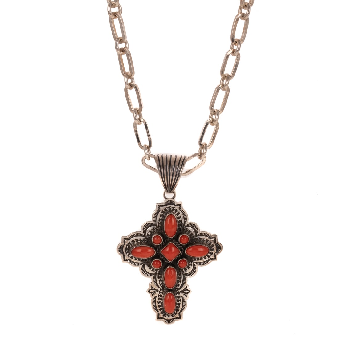 An Albert Jake Coral Cross Pendant in Sterling Silver: Sterling silver coral cross pendant by Navajo artist Albert Jake (b. 1959), signed, 3 in. L, hanging on sterling silver paper clip link chain with hook clasp, 26 in. L, 65.3 grams Provenance: Property