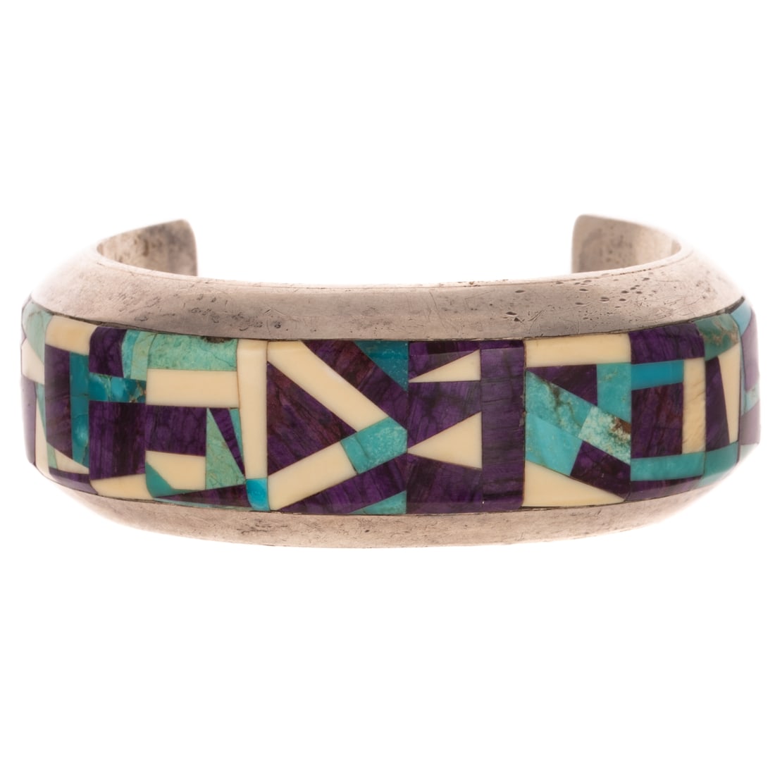 A Larry Castillo Inlay Cuff in Sterling Silver: Sterling silver wide cuff bracelet made by Navajo artist Larry Castillo featuring a geometric design inlay stones including sugilite, shell, and turquoise, 1 in. W, signed, 2 in. interior Diam., 90.7 
