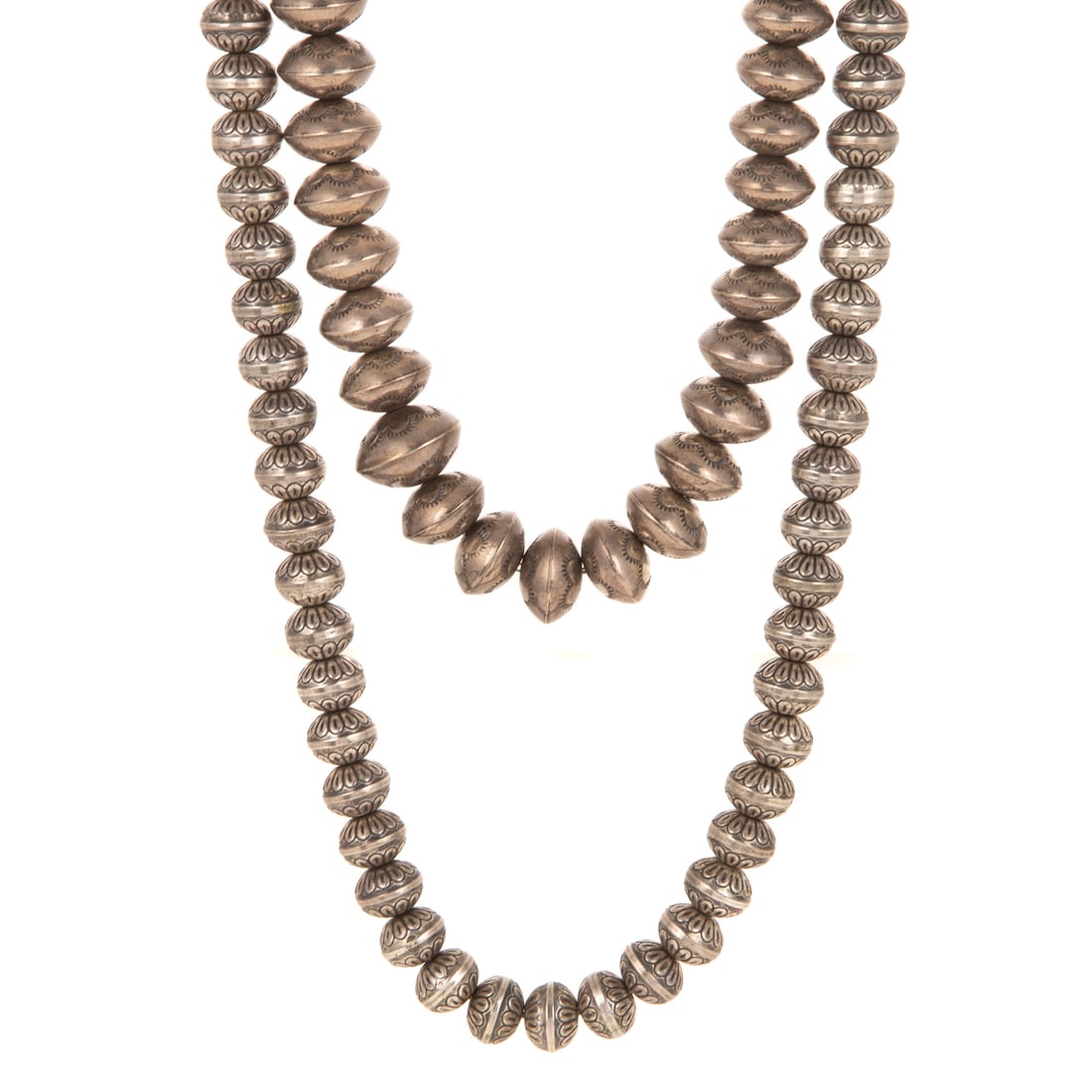 Two Navajo Engraved Beaded Necklaces in Sterling Silver: Two sterling silver Navajo beaded necklace (also known as Navajo pearls) featuring hand engraved beads, one strand features graduated beads and one features same size beads, hook clasps, both measure 