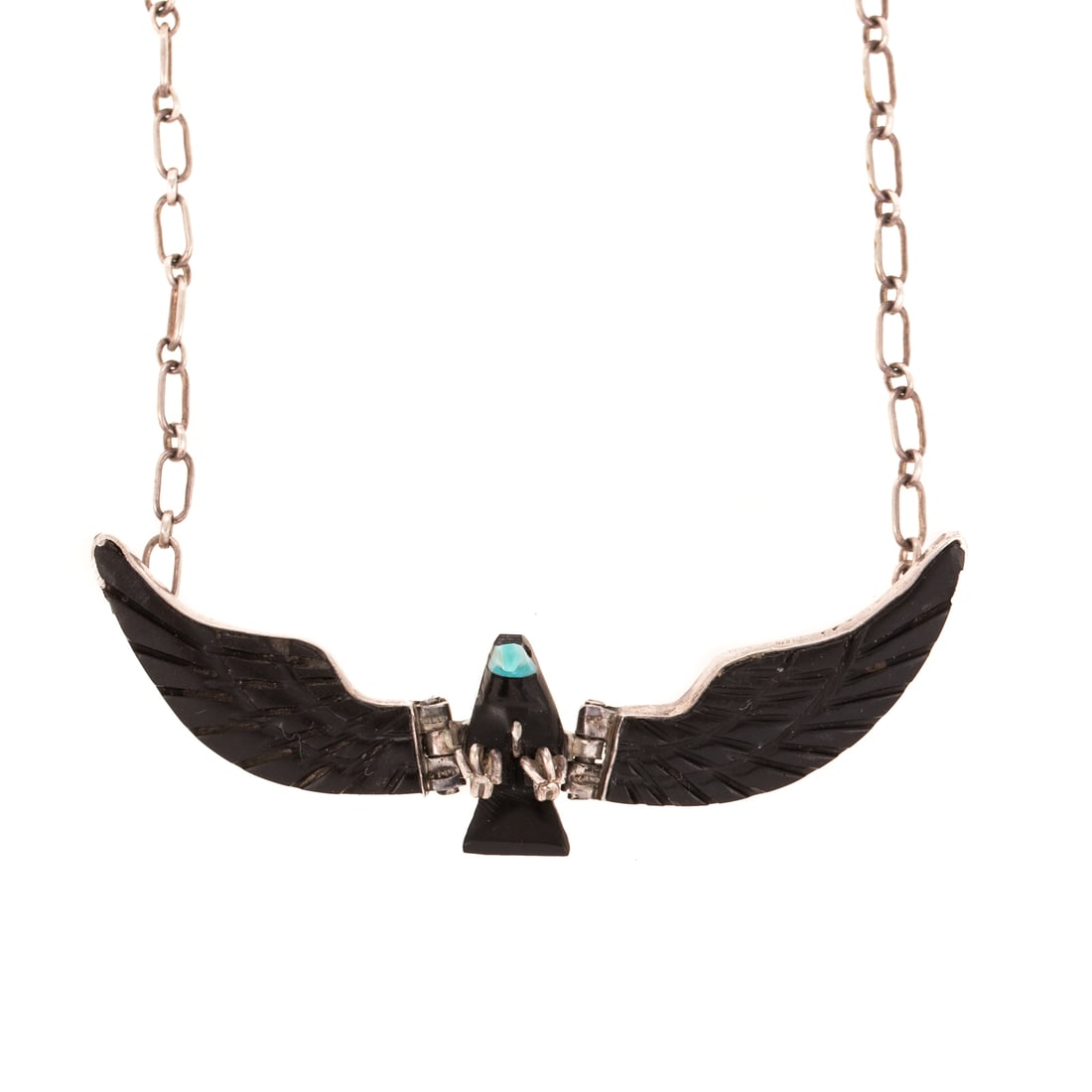 A F. Tom Carved Eagle Necklace in Sterling Silver: Sterling silver necklace by Navajo artist F. Tom featuring articulating hand carved black onyx wings and body with turquoise beak, signed, 3 in. W, removable open link sterling silver chain with sprin