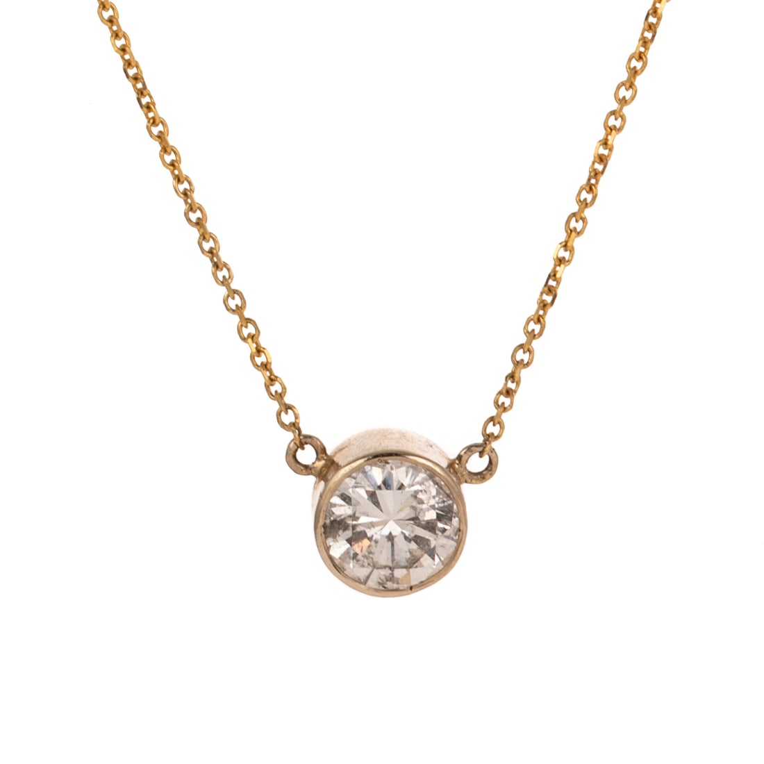 A 1.70 ct Bezel Set Diamond Pendant in 18K: 18K yellow gold necklace featuring a round brilliant cut diamond weighing approx. 1.70 carats with an average color grade of I - J and an average clarity grade of SI bezel set affixed to a cable link 
