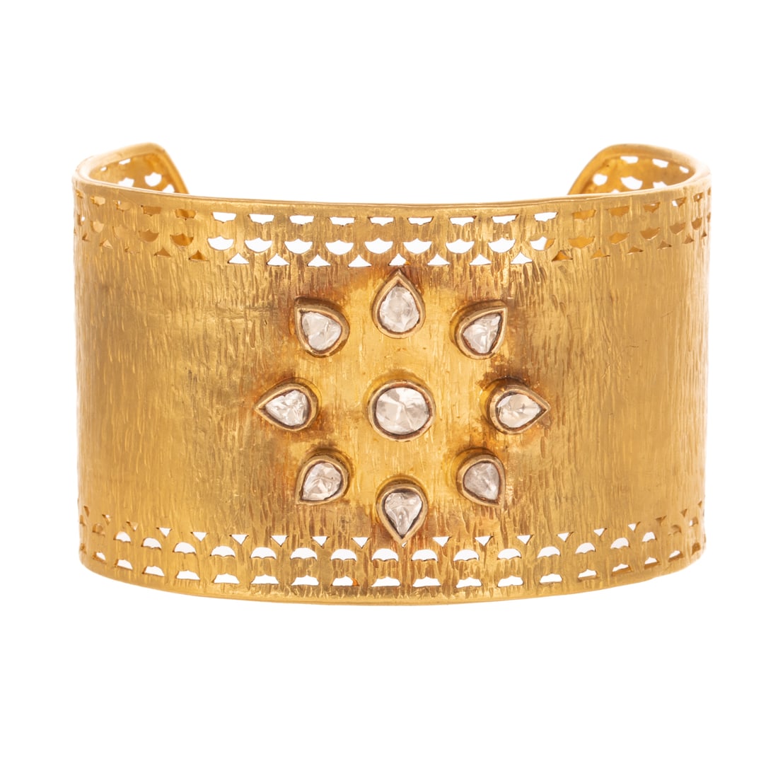 A Wide Diamond Flower Cuff in 22K: 22K yellow gold cuff featuring nine round and pear shaped diamonds weighing approx. 2.60 ctw bezel set in a flower, hammered finish with cut out details, signed "SG," 2 5/8 in. interior Diam., 62.8 gr