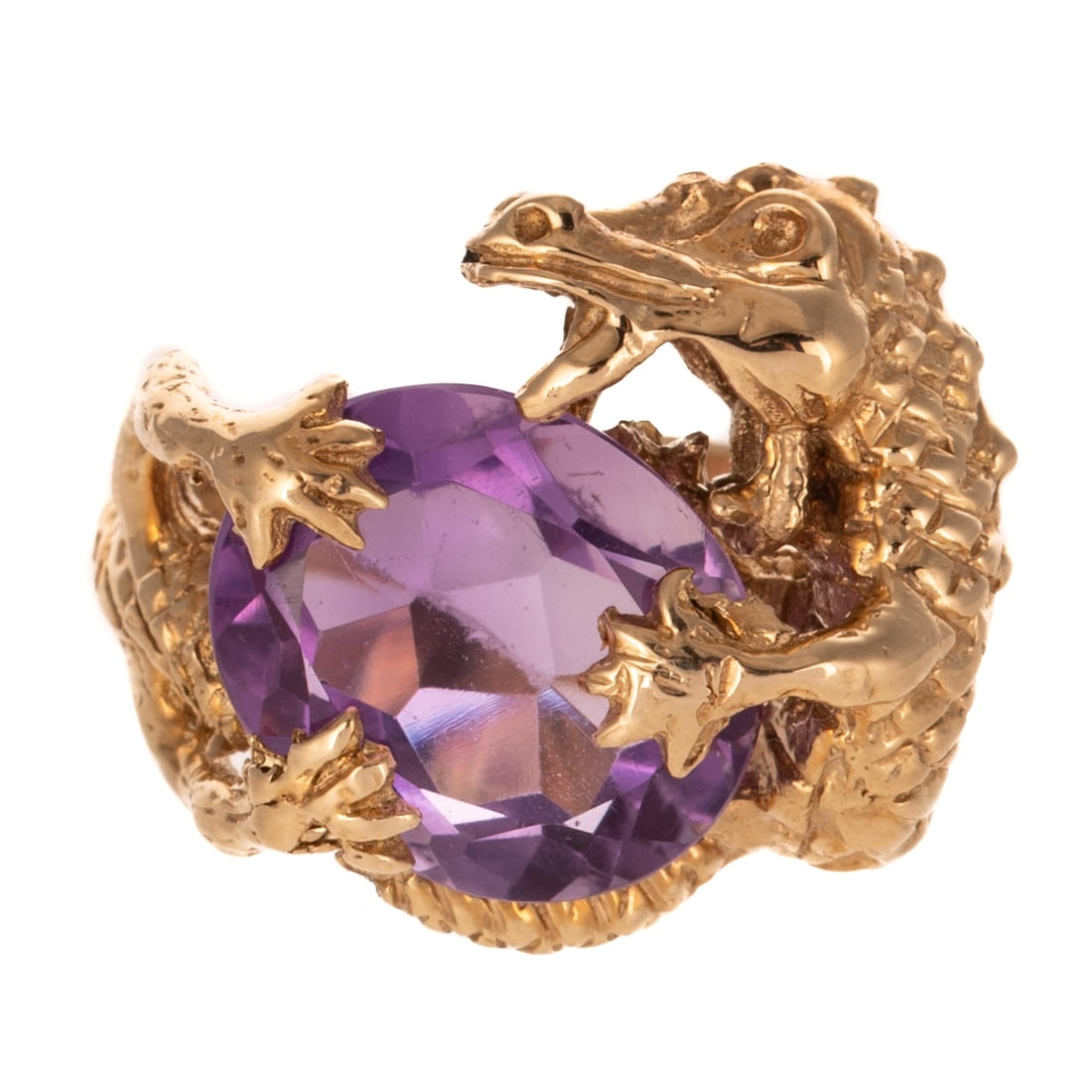 An Amethyst Dragon Ring in 10K: 10K yellow gold ring in the form of a detailed dragon hugging a faceted oval shaped amethyst measuring approx. 14 x 11 mm, scale detail shank, approx. sz 6, 12.4 grams