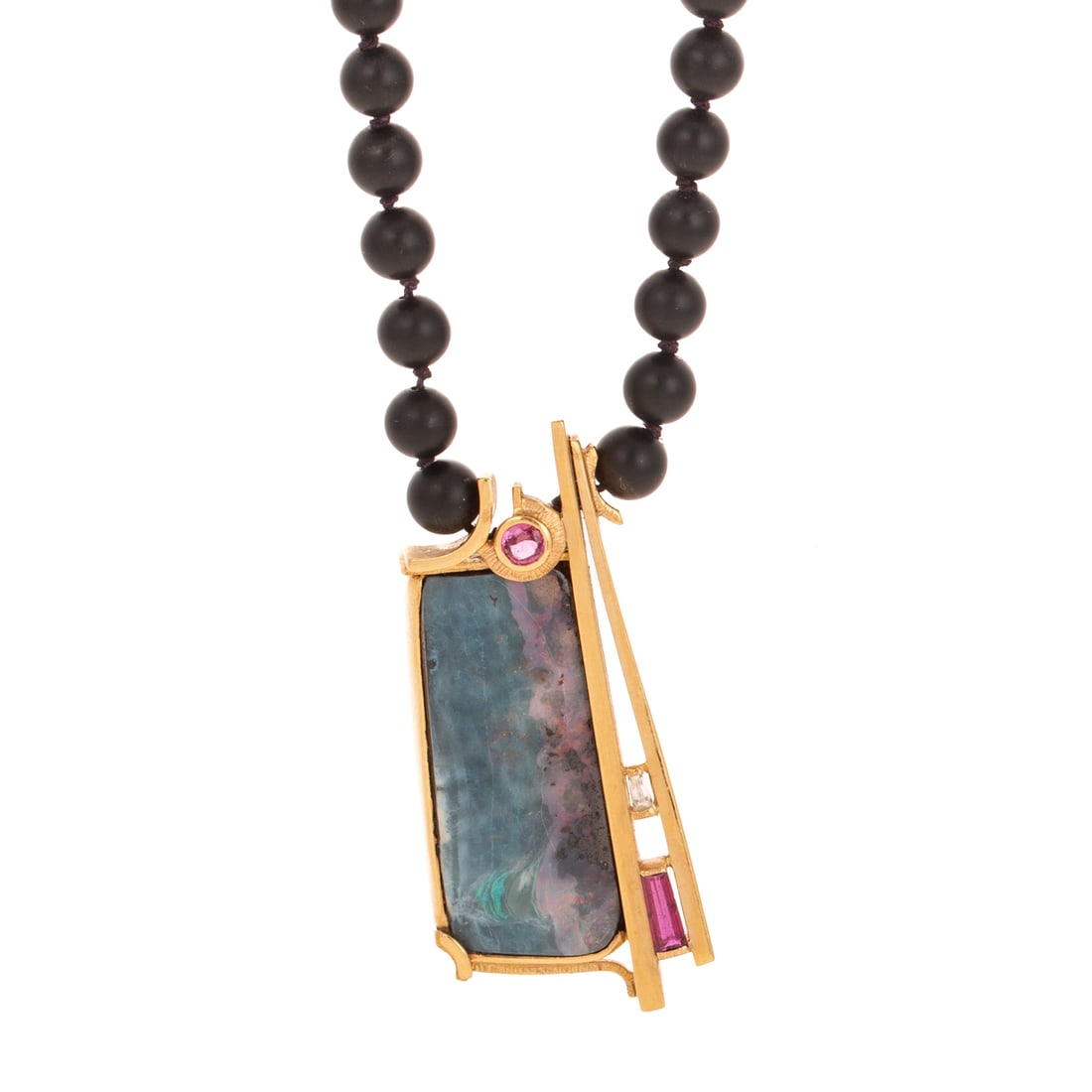 An Opal, Ruby & Diamond Necklace in 18K: 18K yellow gold central pendant featuring bezel set rectangular opal with geometric frame featuring bezel and bar set rubies and diamonds, sold gold back, 1 3/4 in. L, hanging on 5 mm matte finish bla