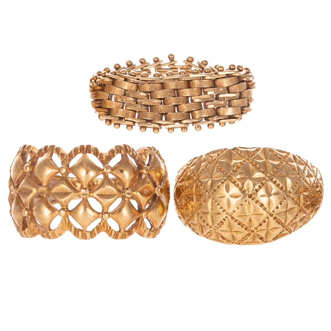 A Trio of Gold Rings in 14K: 1) 14K yellow gold quilted dome ring featuring bright cut engraving and stamped designs, sz 5.5, 2) 14K yellow gold filigree dome ring featuring a fluted border, high polish and cut designs, sz 5.25, 