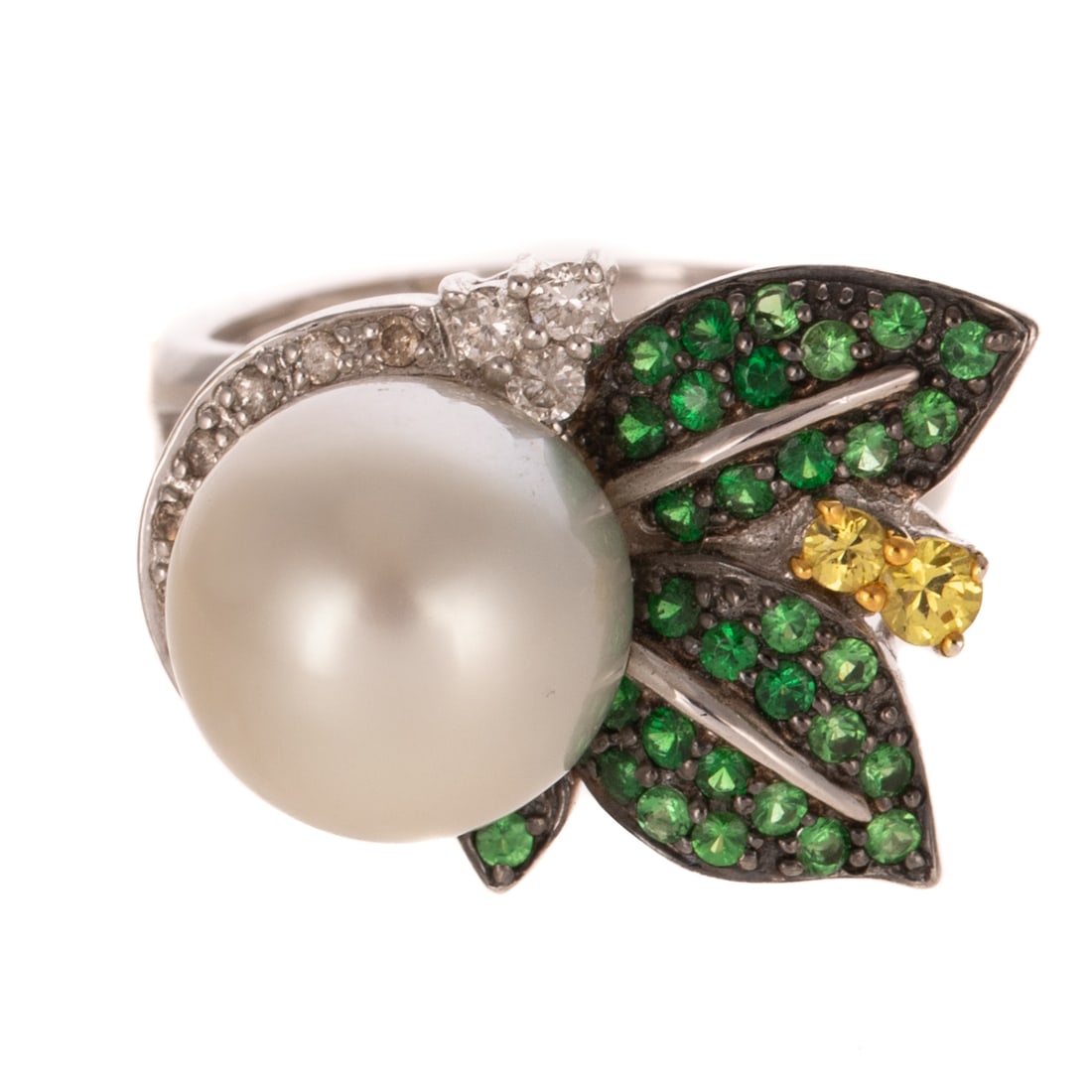 A Pearl & Gemstone Foliate Ring in 18K: 18K white gold ring featuring a South Sea white pearl measuring 11.5 mm set in a partial bezel of round prong set diamonds with round tsavorite garnet bead set leaves sprouting from one side, round