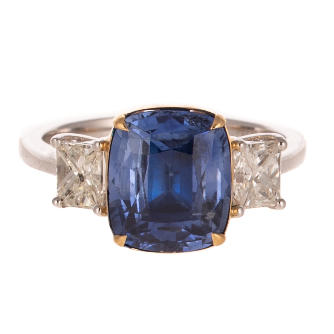 A GIA Unheated 4.46 ct Sapphire & Diamond Ring in 18K: 18K white gold ring by Oscar Friedman featuring a cushion cut unheated sapphire weighing 4.46 carats, accompanied by GIA Gemological Report #2231596973, set in 18K yellow gold basket head with two wel
