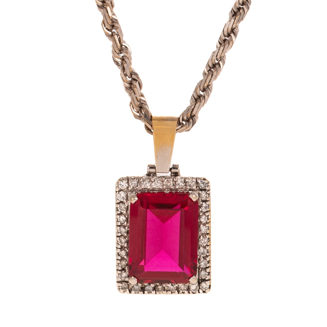 A Substantial Synthetic Ruby Pendant Necklace in 10K: 10K white gold pendant necklace featuring a substantial synthetic emerald cut ruby measuring 20.1 x 15.1 mm prong set with a diamond halo weighing approx. 1.50 ctw, 1 1/2 in. L, suspended from a rope
