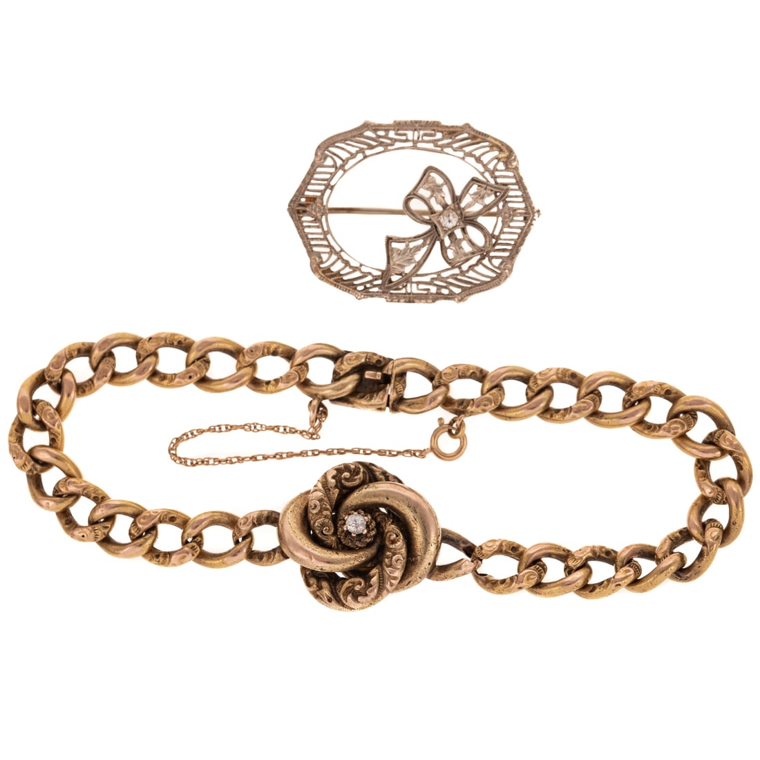 A Victorian Knot Bracelet & Filigree Pin in Gold: 1) c.1890's 14K yellow gold knot bracelet designed with a larger central knot with an Old European cut diamond weighing approx, 0.08 ct with an alternating textured curb link bracelet, hidden box clas