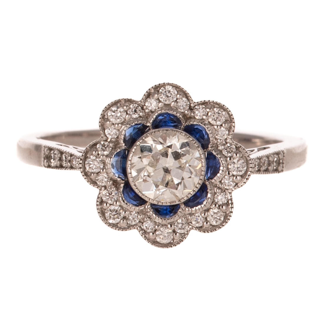 A 0.42 ct Diamond & Sapphire Flower Ring in 14K: 14K white gold ring featuring an Old European cut diamond weighing approx. 0.42 ct with an average color grade of K - L and an average clarity grade of VS bezel set in the center of an small inner rin