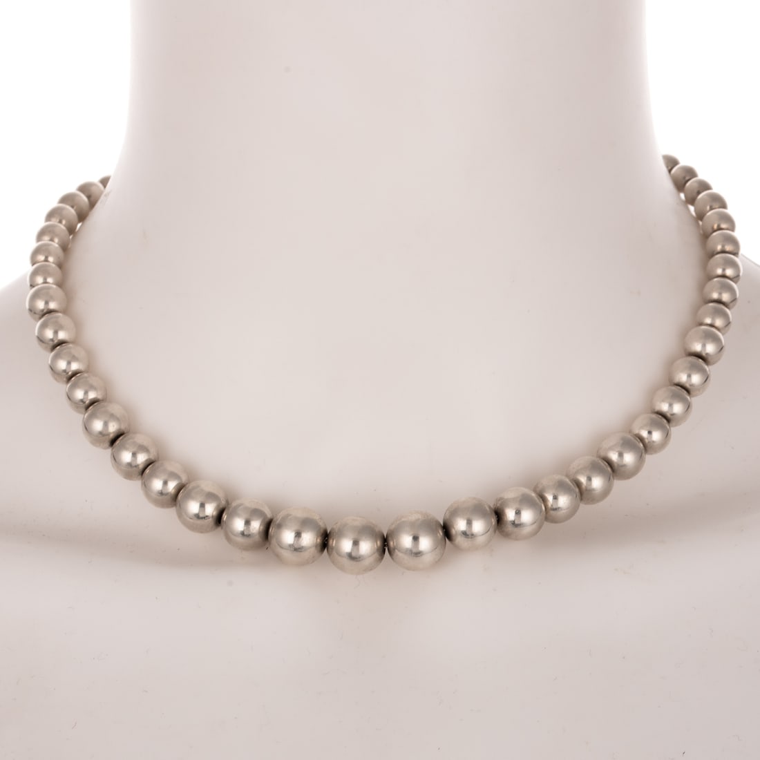 A Tiffany & Co. Graduated Bead Necklace in Sterling Silver: Sterling silver beaded necklace by Tiffany & Co, high polish graduated bead ranging in size from 11 mm in the front to 6 mm in the back, lobster clasp, signed round tag in the back, 16 in. L, 27.6 gra