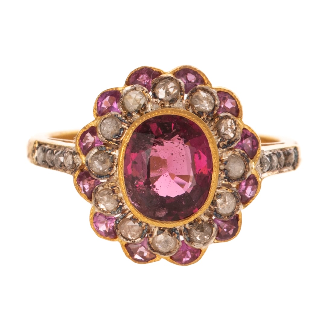 A Pink Tourmaline & Diamond Flower Ring: Vermeil ring featuring an oval shaped pink tourmaline weighing approx. 1.20 cts bezel set in the center of a ring of rose cut diamond bead set petals and an outer ring of rose cut pink tourmaline bead
