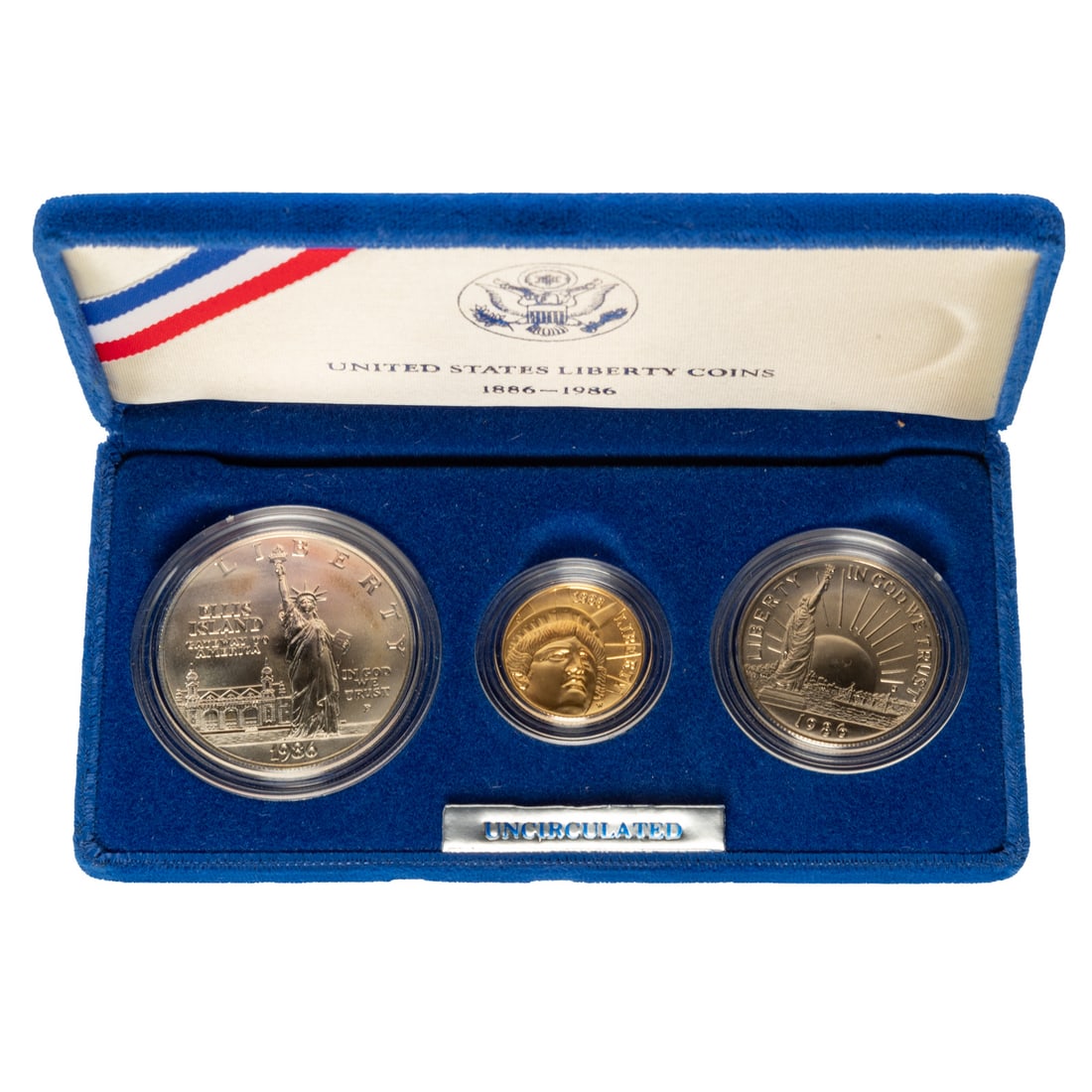 1986 Three Coin Uncirculated Set with $5 Gold: Statue of Liberty/Ellis Island silver dollar, Liberty Silver Half and $5 Unc Statue of Liberty which is .2418 troy oz gold Provenance: Lifetime numismatic property of a long time Baltimore collector