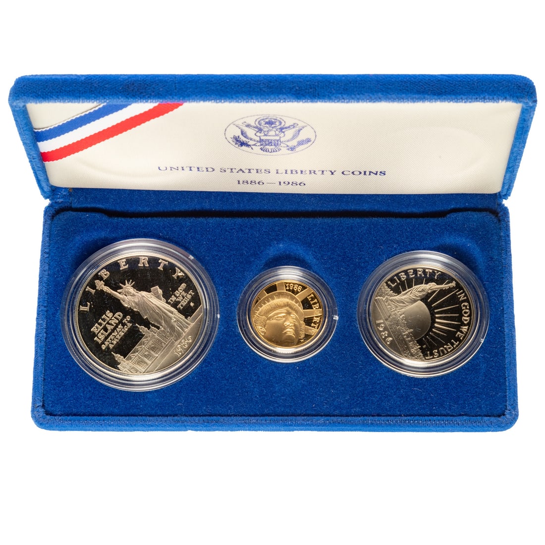 1986 Three-Coin Liberty Proof Set with $5 Gold: 1986 Liberty/Ellis Island four-coin commemorative Proof Set with Ellis Island/Statue of Liberty Silver Proof Dollar, Liberty Silver Proof Half and Proof $5 Statue of Liberty (.2418 toz gold)