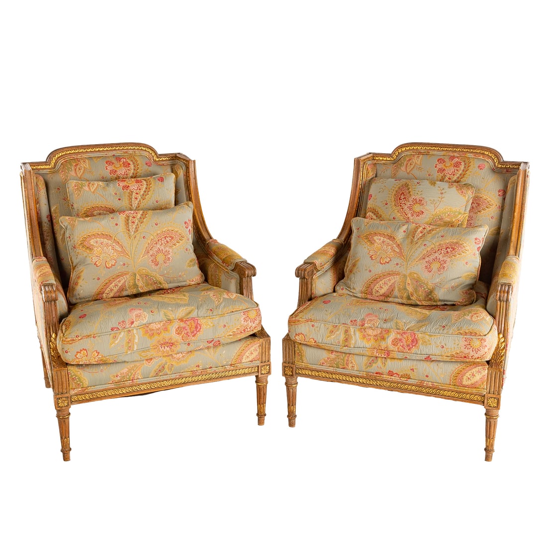 A Pair of Louis XVI Style Occasional Armchairs: A pair of carved fruitwood and partial gilt armchairs, upholstered back, sides and cushioned seat, scroll knuckles extending into turned stop fluted legs, each: 34 in. H, 27 3/4 in. W, 27 in. D