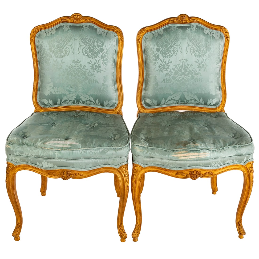 A Pair of Louis XV Style Carved Giltwood Side Chairs: Carved curvelinear crest rails, upholstered backs and seats over carved aprons extending into cabriole legs, 37 1/2 in. H, 21 in. W, 17 in. D