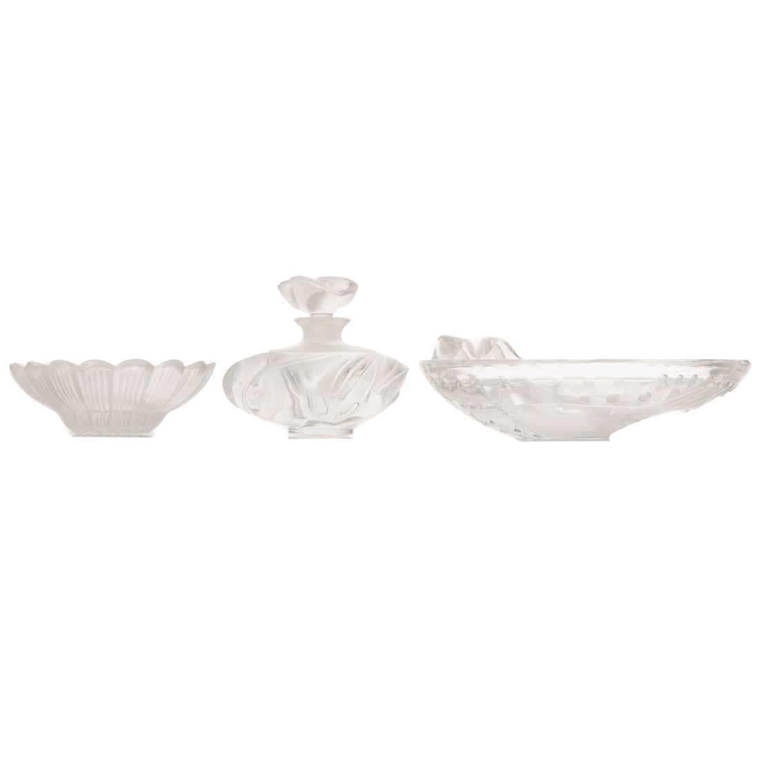 A Lalique "Koi Concarneau" Dish, "Somoa" Perfume, & "Paquerette" Daisy Dish: Includes a colorless Lalique "Koi Concarneau" dish, inscribed "Lalique France" on bottom, 2 in. H, approx. 6 1/4 in. Diam.; a partially frosted Lalique "Somoa" perfume bottle, inscribed "Lalique Franc