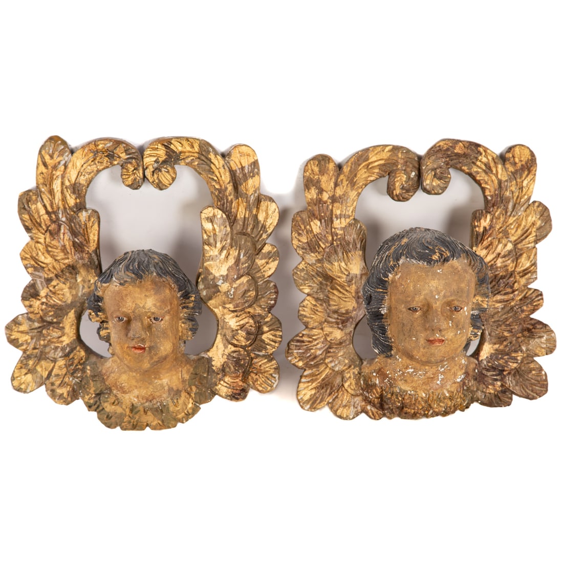 A Pair of French Gilt Wood Putti Wall Busts: A pair of hand carved painted polychrome and gilt wood putti busts with inset glass eyes, wall mounting hardware installed on back, 15 1/2 in. H, 15 3/4 in. W, approx. 7 1/2 in. D