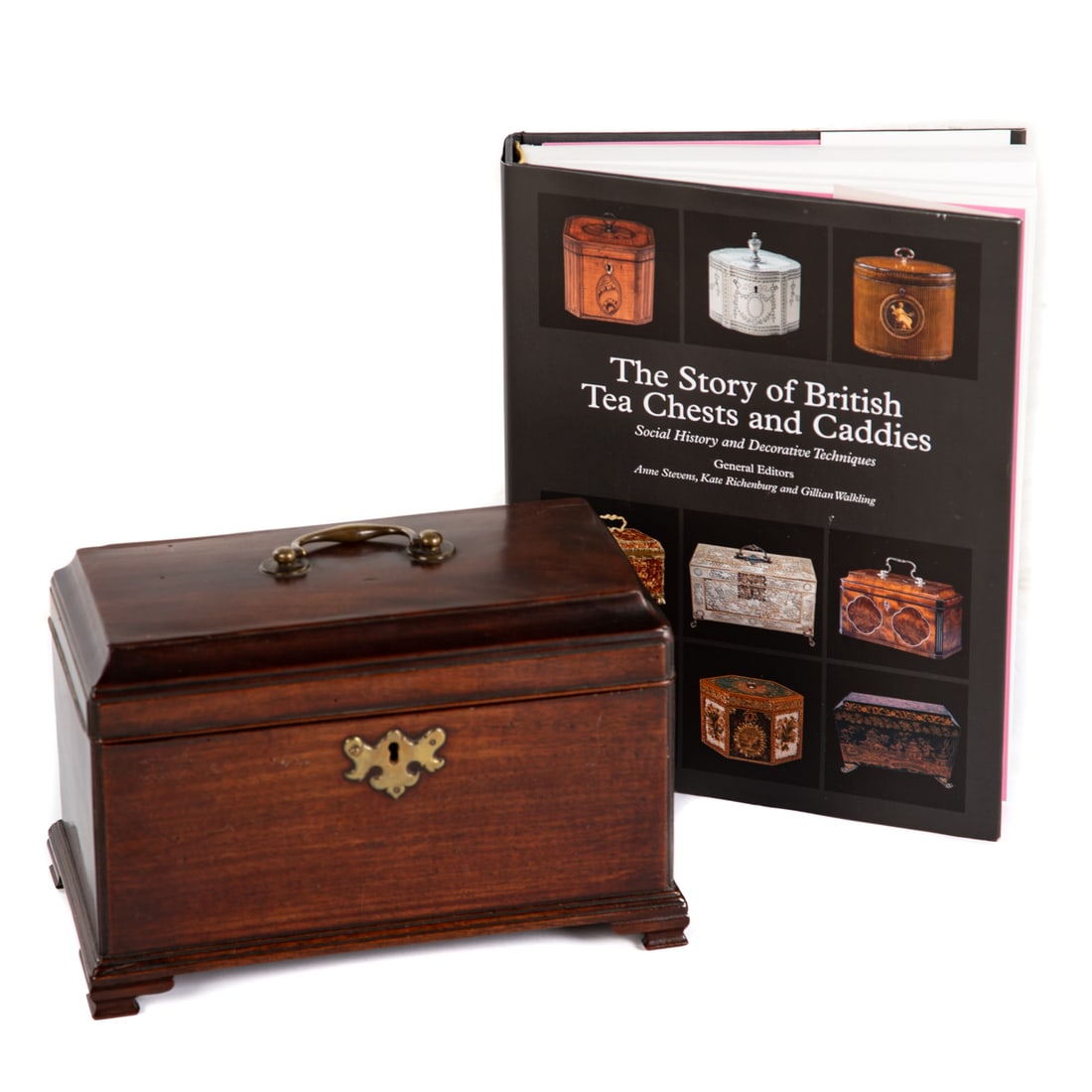 A 19th Century English Tea Caddy & Book: An early 19th century English Georgian mahogany tea caddy with brass hardware and bail top handle, includes key and three canisters, 7 1/2 in. H, 10 3/4 in. L, 5 3/4 in. D; and "The Story of British T