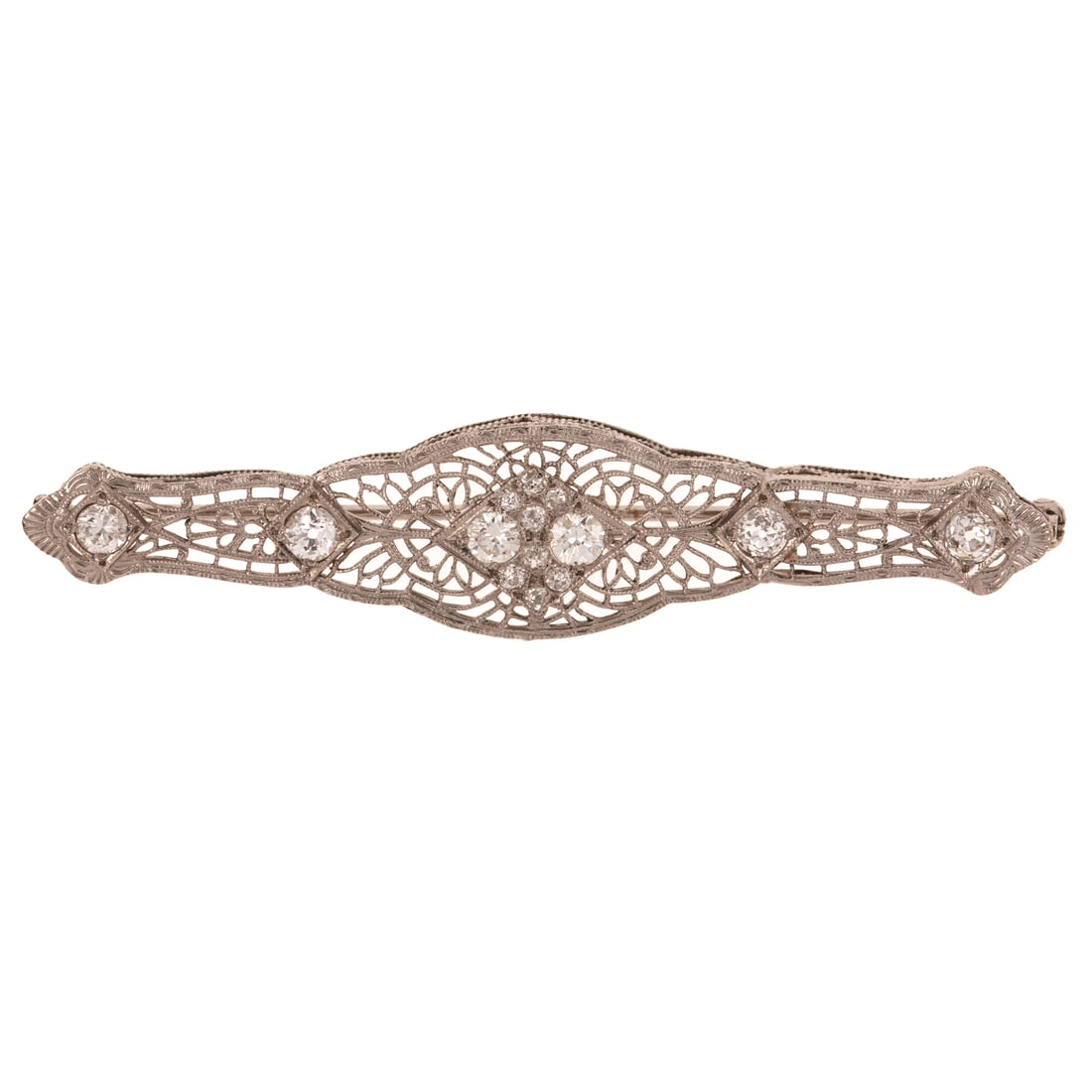 A Diamond Filigree Brooch in 14K: 14K white gold filigree bar pin featuring round and Old European cut diamonds weighing approx. 1.00 ctw with an average color grade of I - J and an average clarity grade of VS, 1 1/2 in. L, 4.7 grams 
