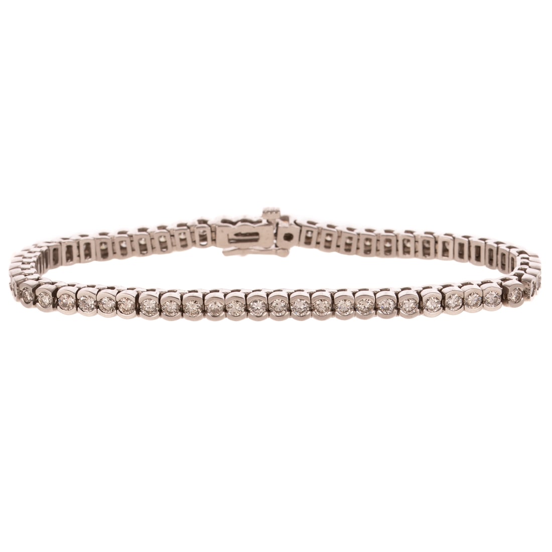 A 5.50 ctw Diamond Line Bracelet in 14K: 14K white gold bracelet featuring round diamonds weighing approx. 5.50 ctw with an average color grade of G - H and an average clarity grade of SI semi bezel set, hidden box clasp with safety latch, 7
