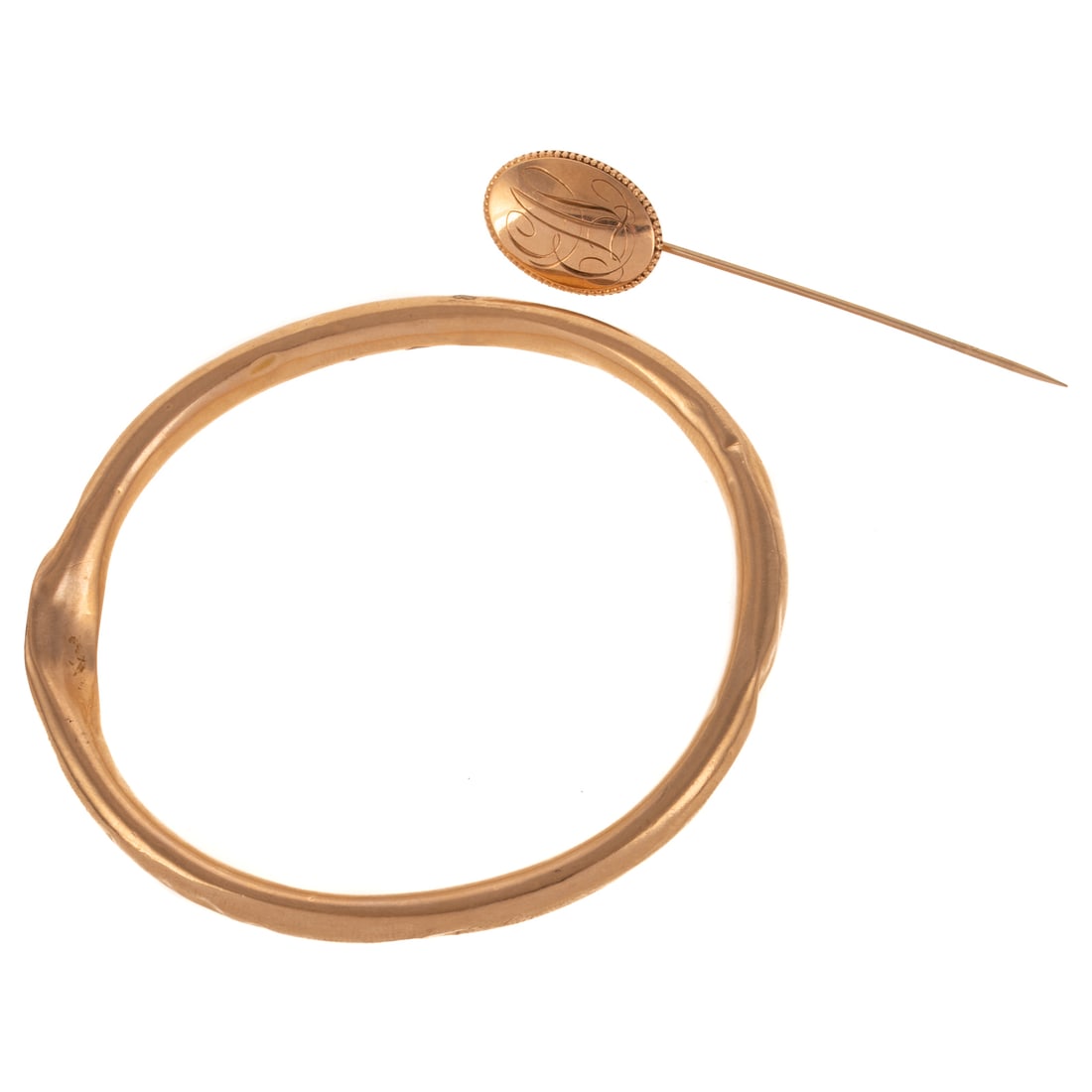 A Monogrammed Bangle & Stick Pin in 10K: 1) 14K yellow gold oval slip on bangle bracelet with monogram on front, 2 1/2 in. interior Diam., and 2) 14K yellow gold oval monogrammed stick pin, 2 1/2 in. L, 9.4 grams tw Provenance: From the