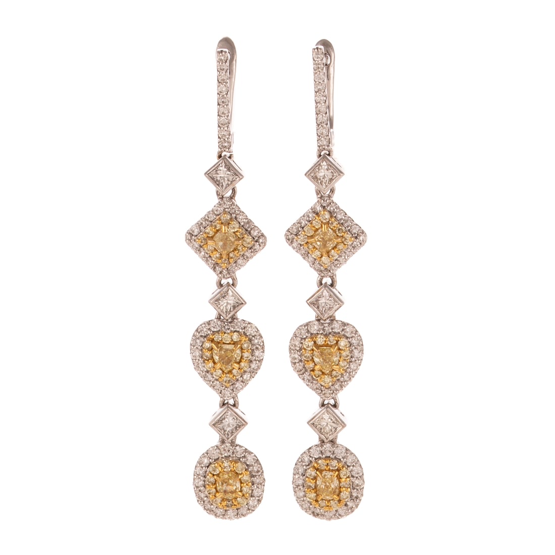 A Pair of Multi-Shaped Yellow Diamond Dangle Earrings in 18K: 18K white gold earrings featuring lines of square, heart, and oval shaped yellow diamonds prong set in the center of individual halos of round yellow diamonds shared prong set and outer halos of round
