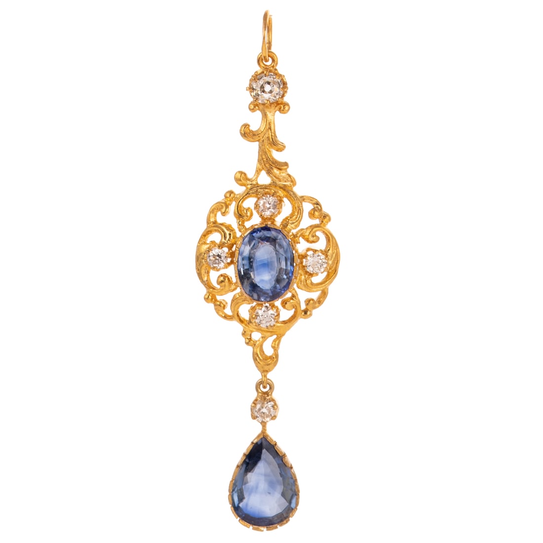 A Sapphire & Diamond Scrollwork Pendant: Vermeil open scrollwork pendant featuring an oval shaped sapphire prong set in the center with Old European cut diamond prong set accents weighing approx. 0.60 ctw with an average color grade of G -