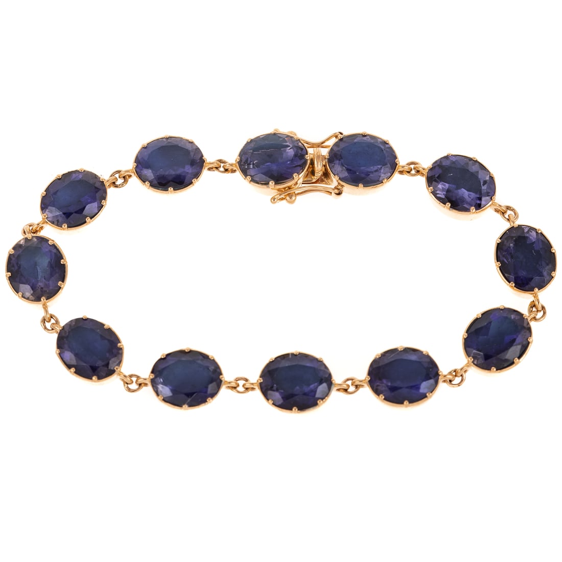 A 23.00 ctw Iolite Line Bracelet in 14K: 14K yellow gold bracelet featuring oval shaped iolite links weighing approx. 23.00 ctw prong set, hidden box clasp with double safety latches, 7 in. L, 20.1 grams