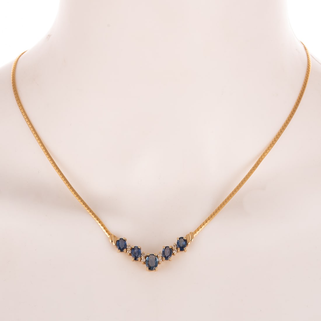 A 3.80 ctw Sapphire & Diamond Necklace in 14K: 14K yellow gold necklace with "V" shape featuring oval sapphires weighing approx. 3.80 ctw alternating with prong set diamonds, snake chain attached to central "V", lobster clasp, 17 1/2 in. L, 8.8 gr