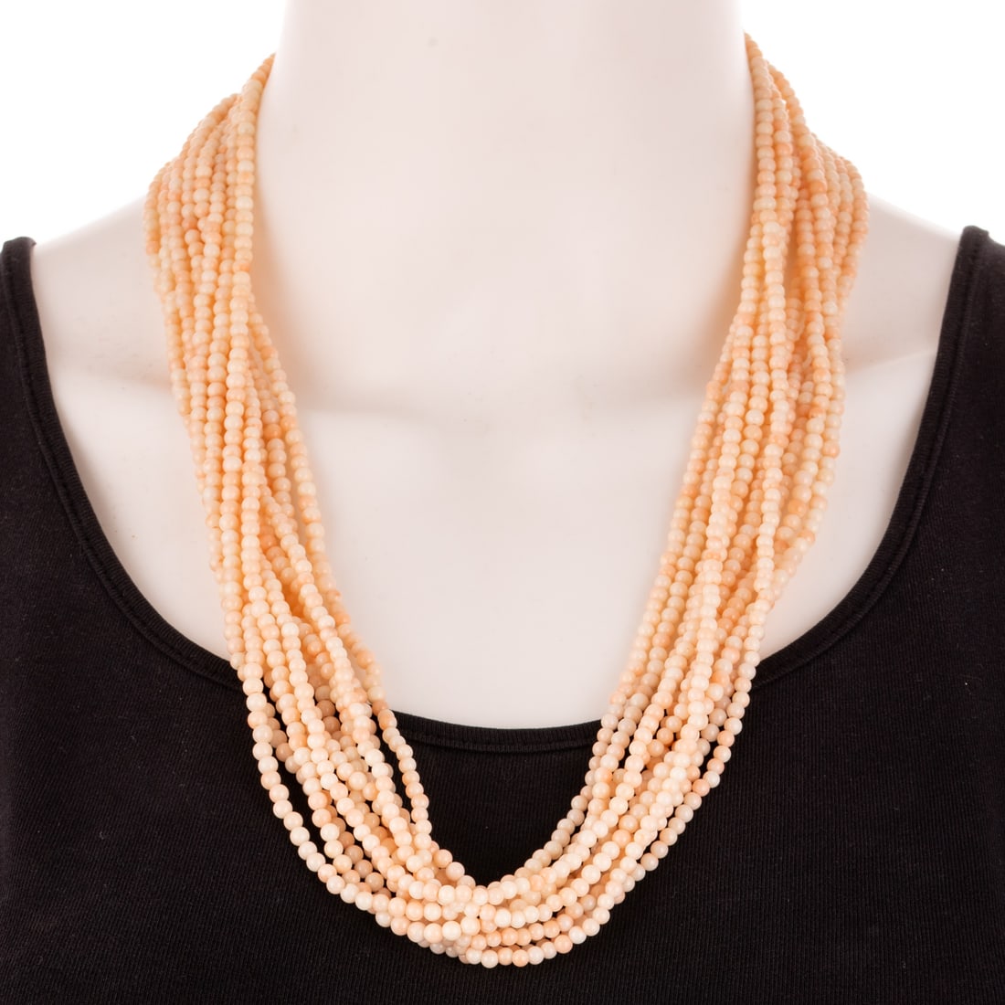 An Antique Multi-Strand Coral Bead Necklace: Late 19th century, 11-strand necklace featuring angel skin coral beads measuring 3.5 - 4 mm, gold filled floral filigree clasp, 25 1/2 in. L, 143.6 grams