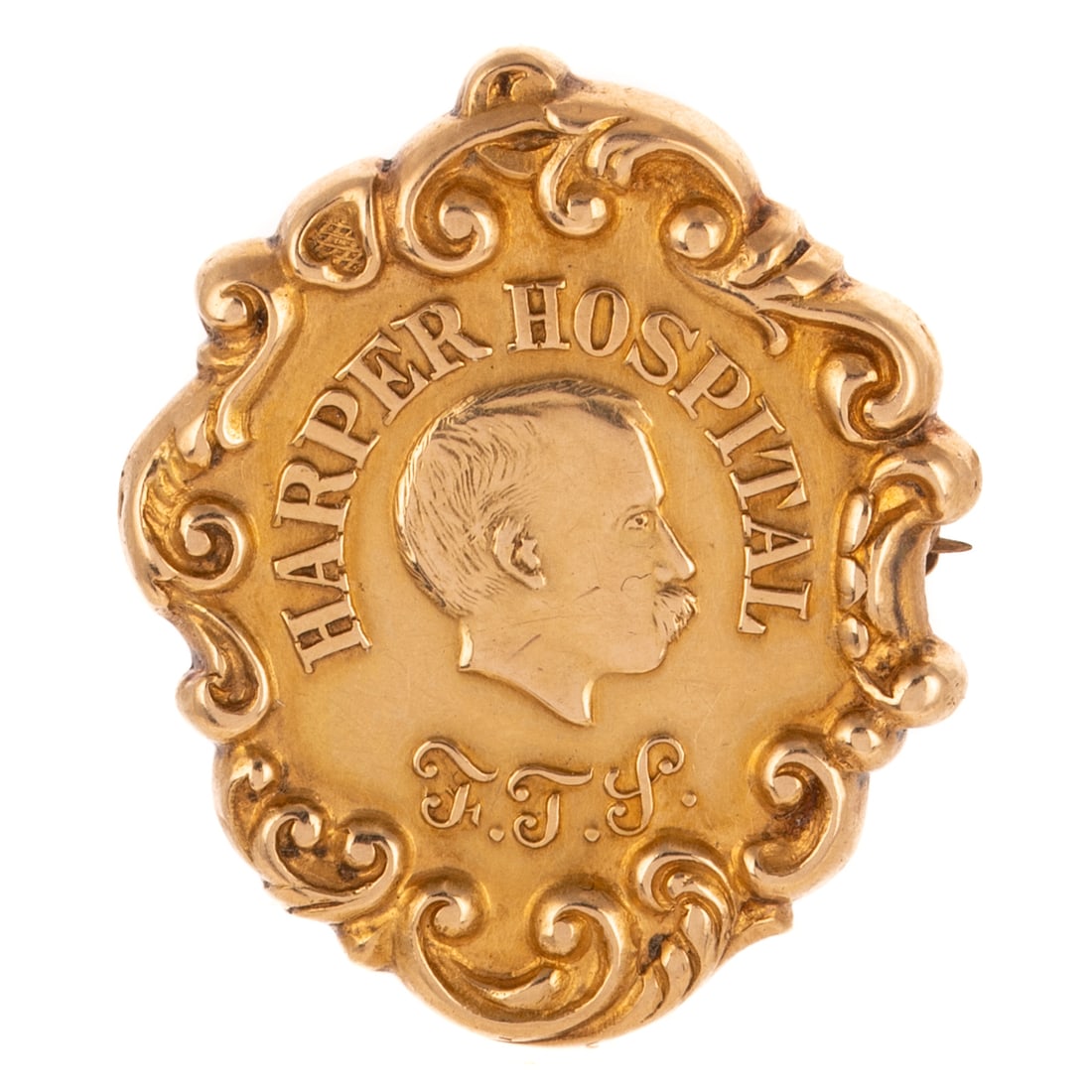 An Antique Pin in 14K: c. 1915, 14K yellow gold pin for Harper Hospital bordered by C-scrolls and scrolling foliage, engraved personalization on reverse and dated "April 21, '15," 1 1/4 in. L, 6.7 grams Provenance: From the