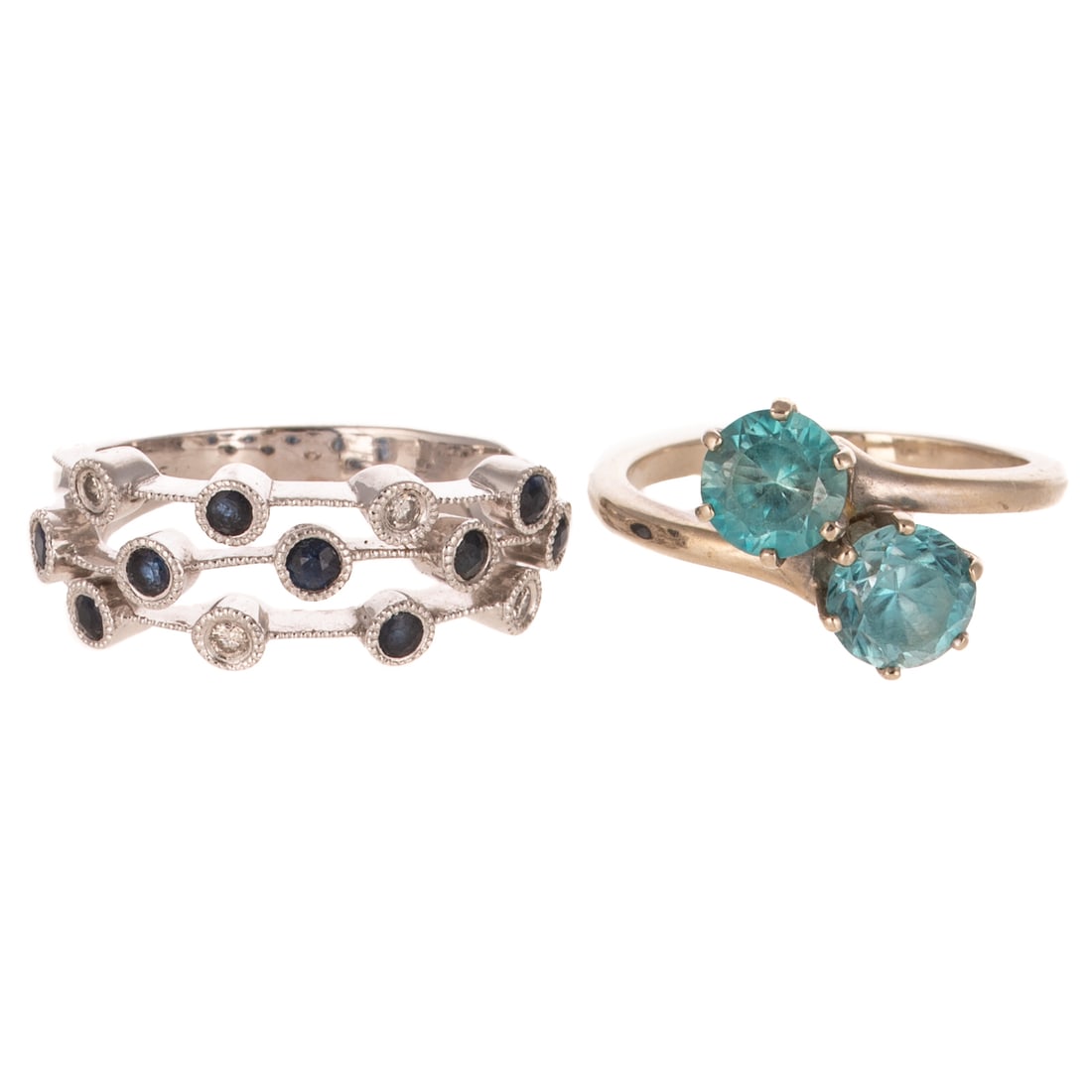A Sapphire & Diamond Band & Blue Zircon Ring in 14K: 1) 14K white gold triple row band featuring alternating round sapphires and diamonds, sz 6.5, and 2) 14K white gold bypass ring featuring round 6 mm round blue zircons, sz 6.5, 7.0 grams tw