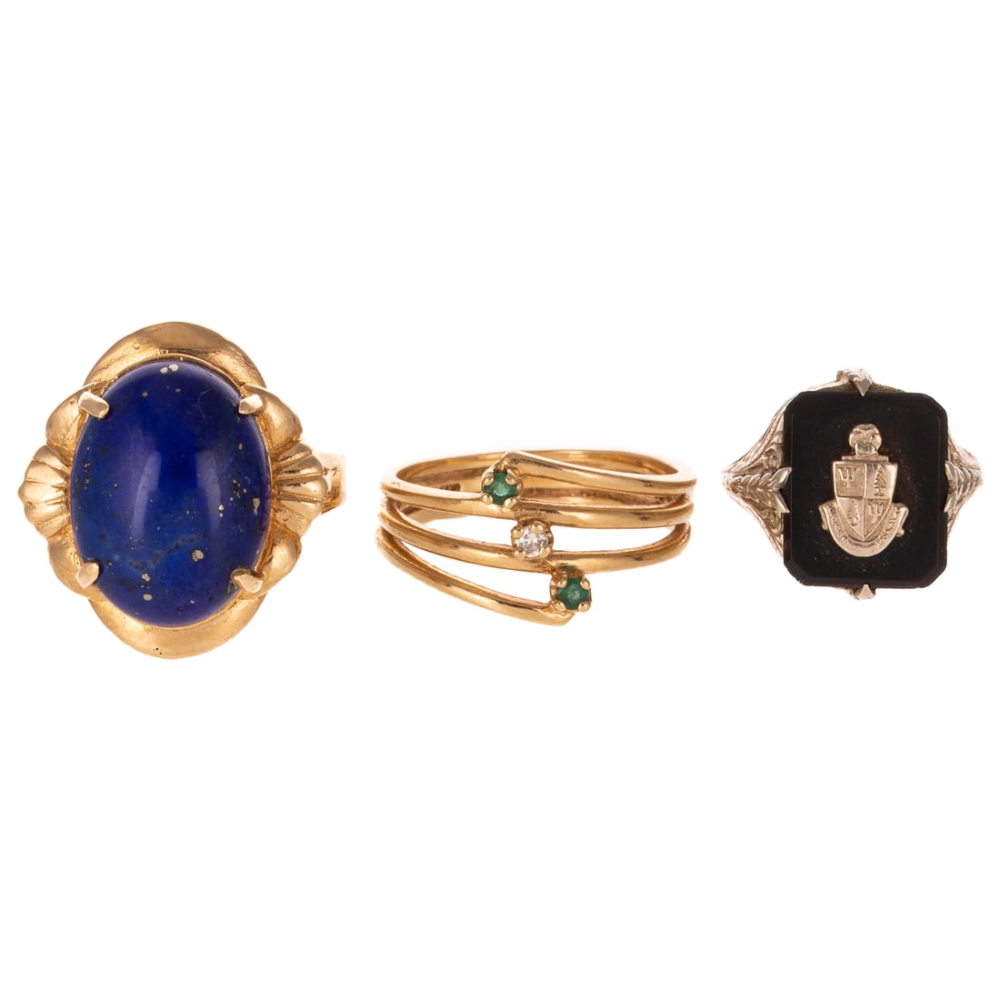 A Trio of Gemstone Rings in 14K: 1) 14K yellow gold ring featuring an oval lapis lazuli measuring 12 x 16 mm in wide scalloped frame, sz 9, 2) 14K yellow gold band with two emeralds and one diamond, all prong set, sz 7, and 3) 14K wh