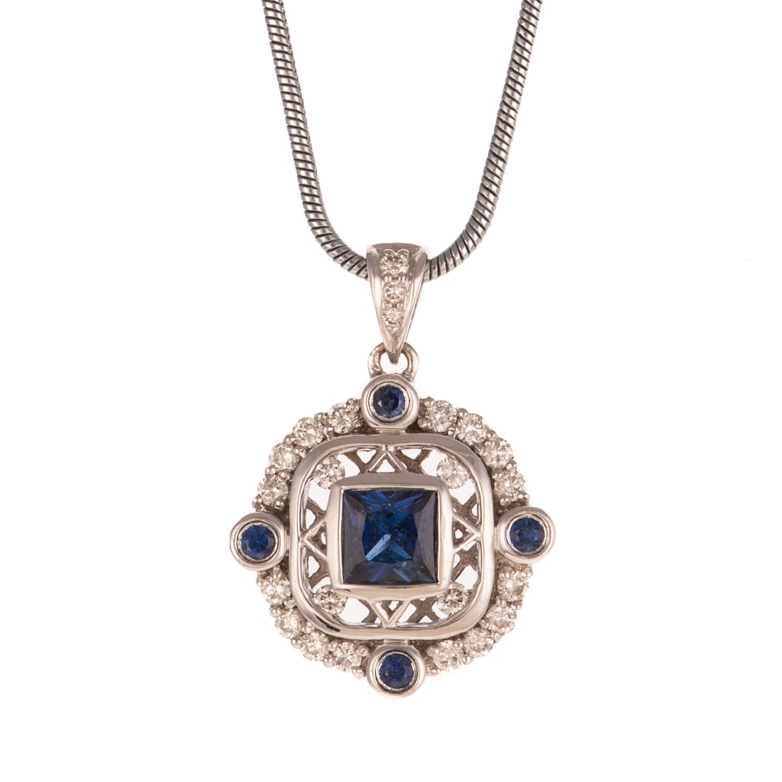 A Sapphire & Diamond Pendant in 14K: 14K white gold pendant featuring a princess cut blue sapphire bezel set in an open frame with round diamond accents at each corner and bordered by four round sapphires bezel set with round diamonds in