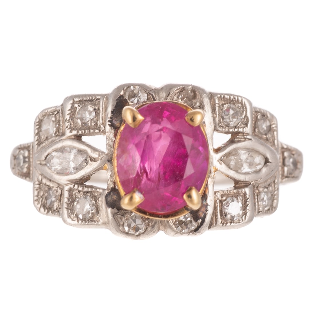 A Fine Pink Sapphire & Diamond Art Deco Ring in Platinum: Art Deco platinum ring featuring an oval shaped pink sapphire weighing approx. 1.41 cts, measuring 6.8 x 5.7 mm, prong set in yellow gold, framed by round and marquise diamonds weighing approx. 0.35 c