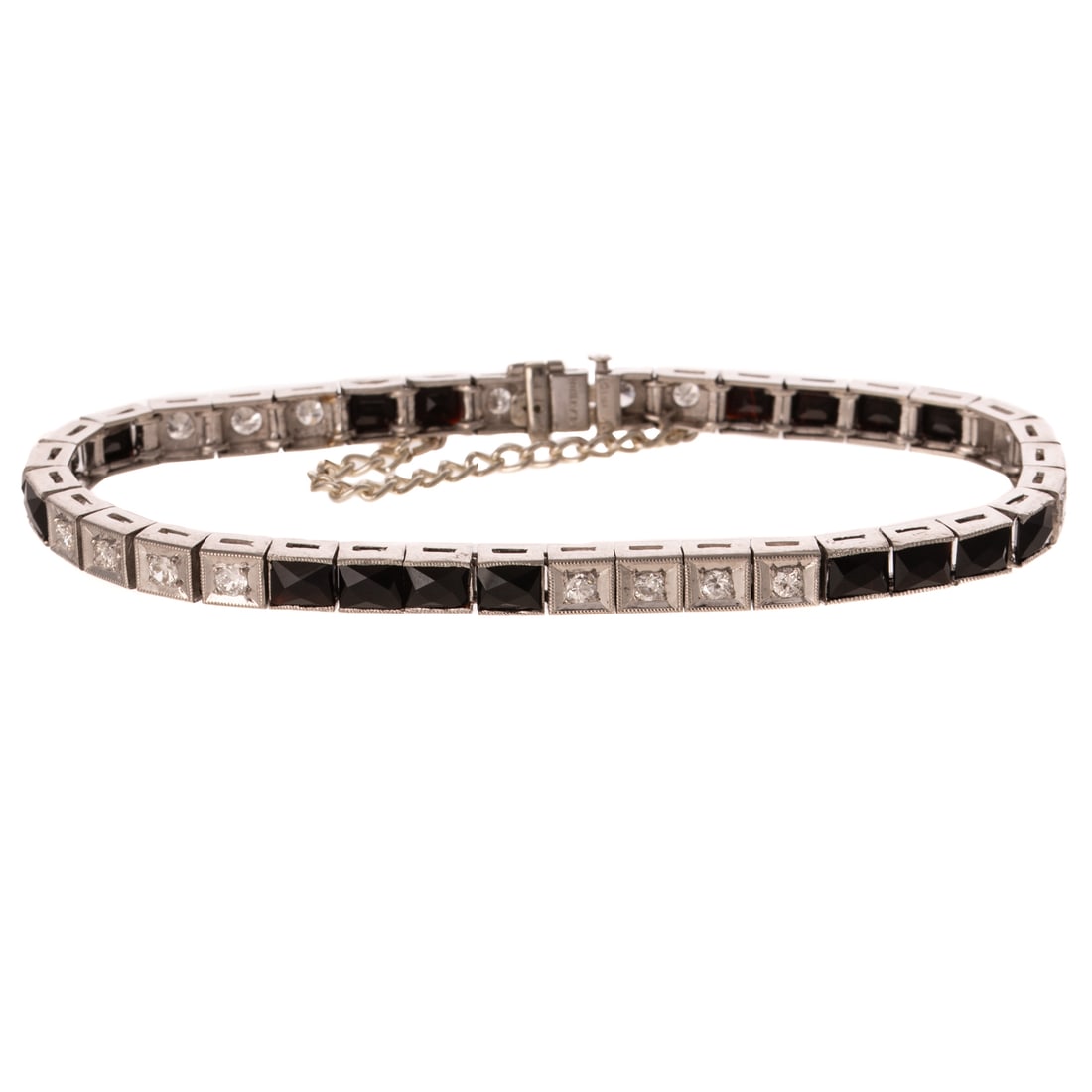 An Art Deco Diamond & Onyx Link Bracelet in Platinum: Platinum line bracelet featuring round diamonds weighing approx. 0.95 ctw with an average color grade of G - H and an average clarity grade of SI set into square box links with milgrain accents altern