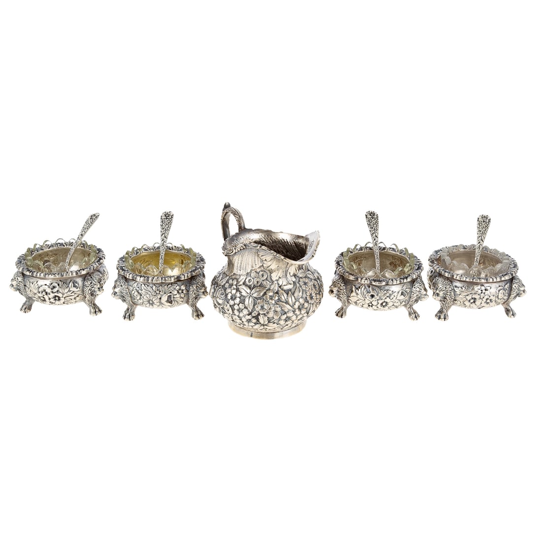 Collection Baltimore Sterling Repousse Tableware: Including: four S Kirk & Son open salts, 1896-1924, the salts with lion's head terminals, 1 1/2 in. H, 2 1/2 in. Diam., 11.6 ozt, with four S Kirk & Son spoons, 1.4 ozt., and a Stieff creamer, model# 