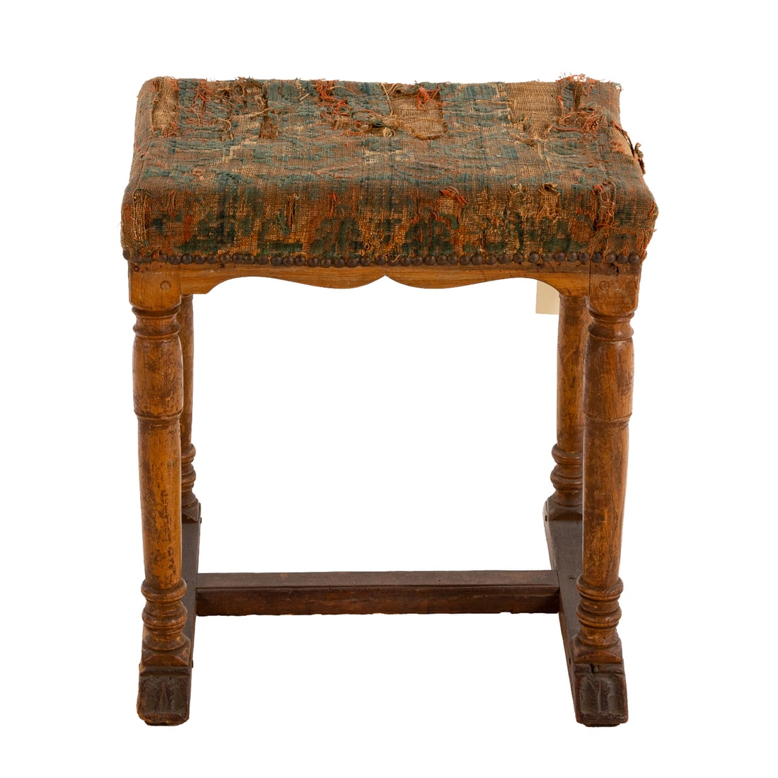 Louis XIII Upholstered Walnut Stool: First half, 17th century, with remains of old needlepoint upholstery attached with hobnails on a shaped apron over turned and stretchered legs, 18 1/2 in. H, 19 in. W, 14 in. D Provenance: Provenance