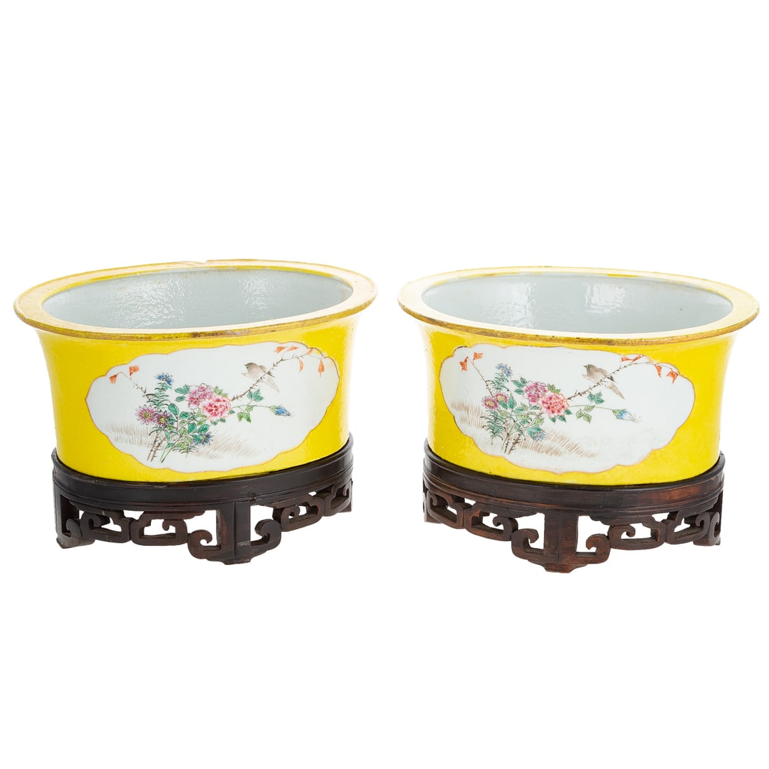 A Pair of Chinese Porcelain Cache Pots: Mid-19th century, a pair of yellow ground Chinese porcelain cache pots with floral and bird decorated cartouches on either side, and gilt trim and accents, includes custom wooden stands, 5 in. H, 10