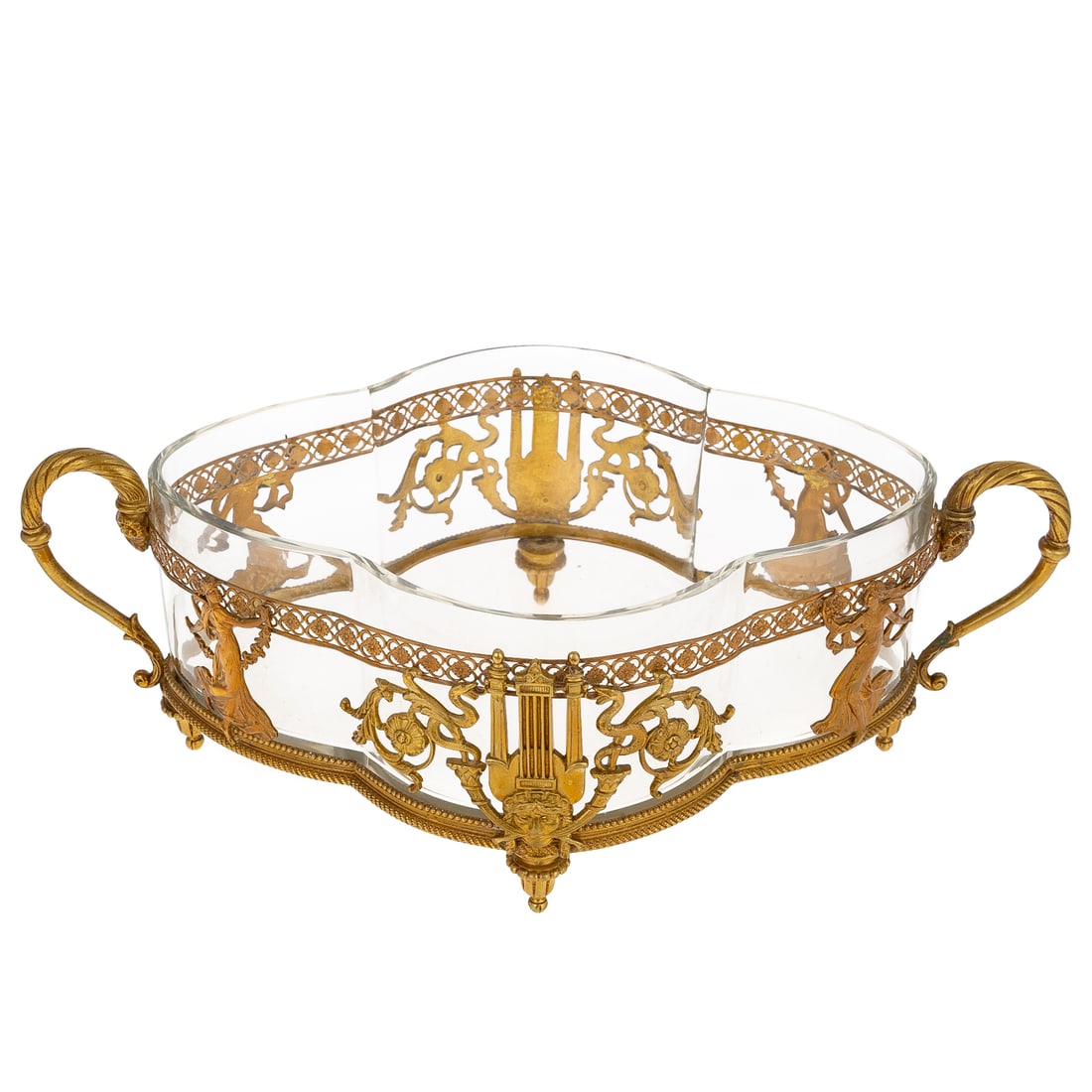 A French Crystal & Gilt Mounted Centerbowl: (French, 19th century) An gilt mounted centerbowl with ram head handles, dancing female classical figure holding grapes, and central lyre with serpents and rosettes, with four raised feet, 4 3/4 in.