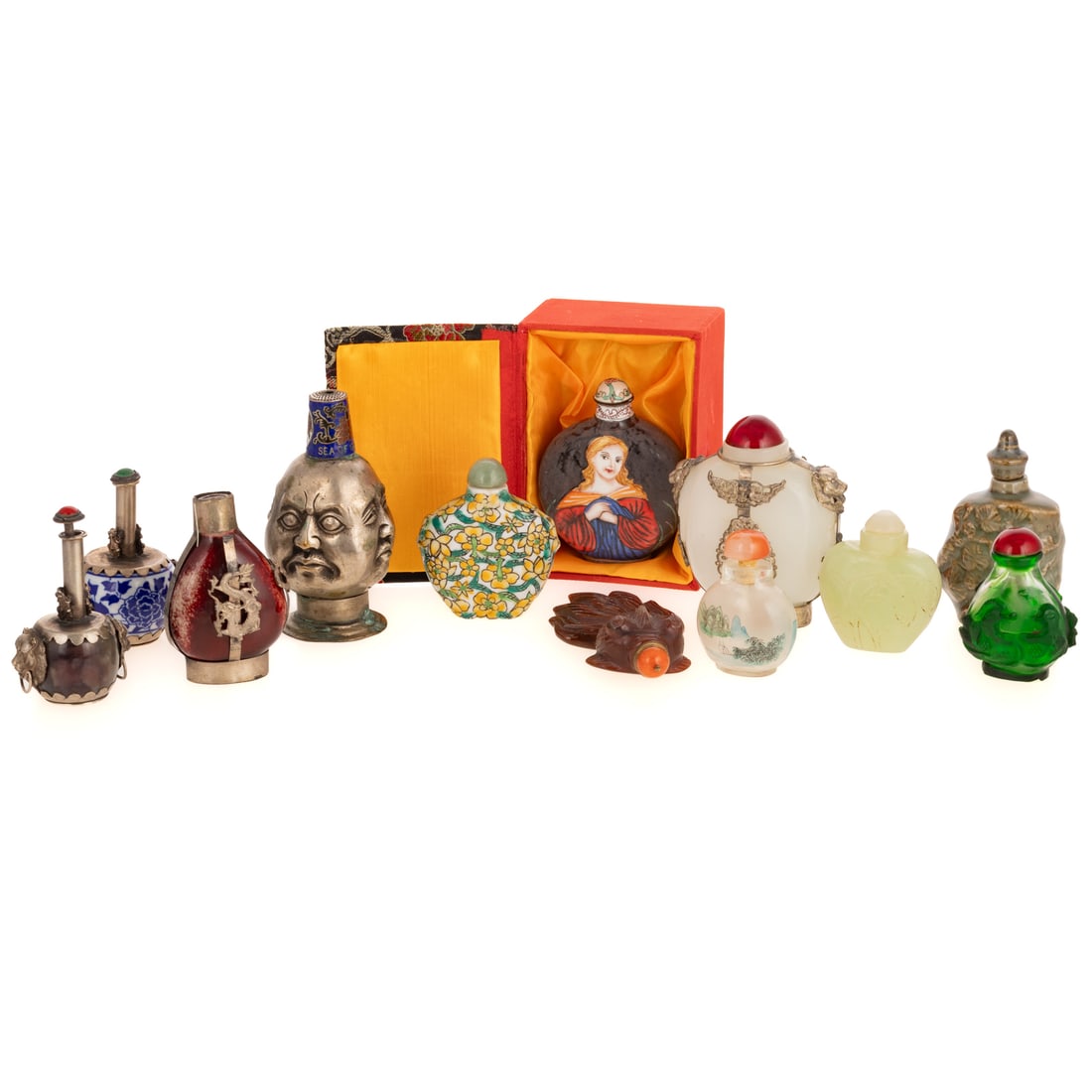 A Collection of Chinese Snuff Bottles: Comprising 13 snuff bottles. Including a silvered snuff bottle depicting the faces of Buddha cast in high relief, 3 3/4 in. H; a Chinese Tibetan style stone and blue and white porcelain snuff bottles