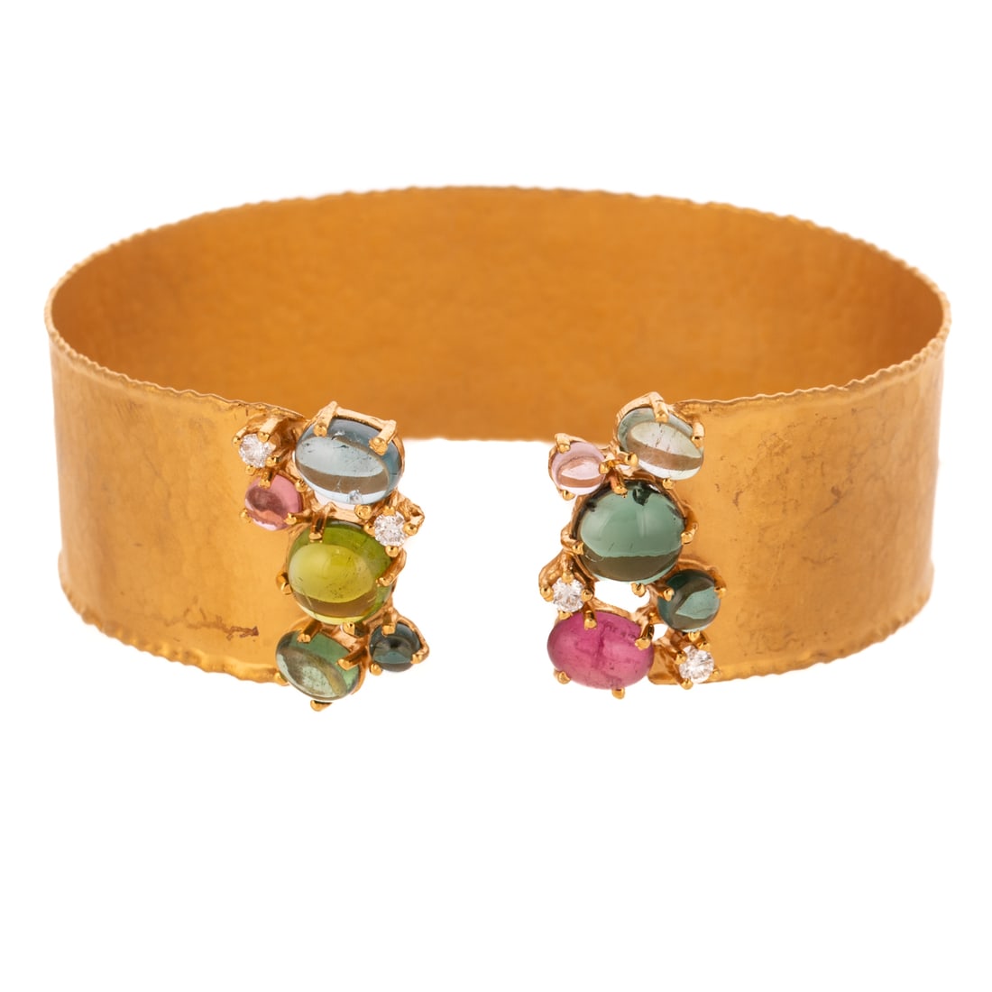A Multi-Color Tourmaline Cuff by Marika in 14K: 14K yellow gold cuff bracelet by Marika from the Desert Gold Collection featuring multi colored pink, blue and green cabochon tourmalines set with diamond accents, finely hammered finish cuff, 3/4