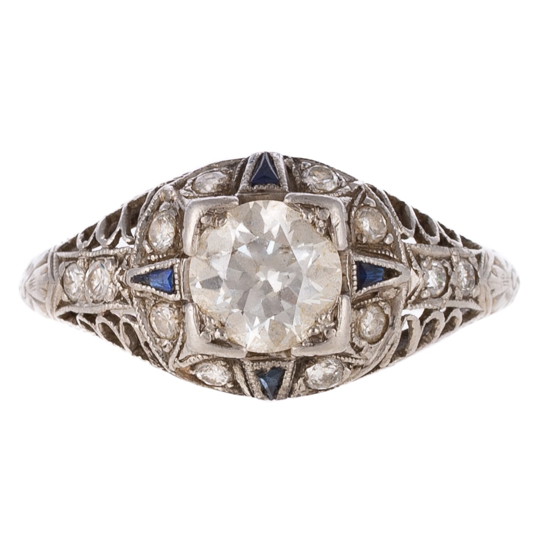 An Art Deco Diamond & Sapphire Ring in Platinum: c.1920s, platinum ring featuring an Old European cut diamond weighing approx. 0.80 carats with an average color grade of I - J and an average clarity grade of VS, set in center of filigree engraved mo