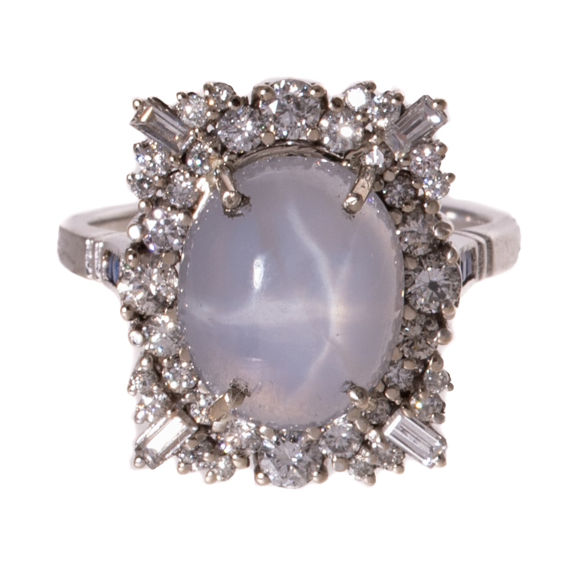 A Star Sapphire & Diamond Cocktail Ring in 14K: 14K white gold ring featuring an oval bluish grey star sapphire weighing approx. 5.24 carats with baguette and round diamonds set in a rectangular frame, approx. 0.80 ctw with an average color grade
