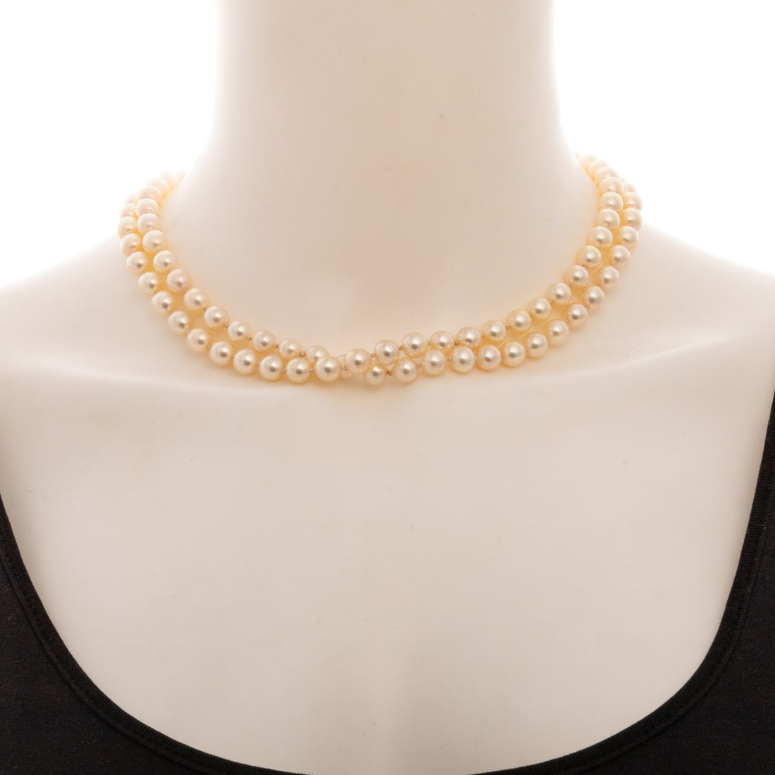An Opera Length Strand of 7 - 7.5 mm Pearls: 14K yellow gold oval Chinese character clasp with strand of 7 - 7.5 mm cultured pearls, very high lustre and little to no blemishes, 34 in. L, 55 grams Provenance: From the Estate of Mary "Mea" Taylor