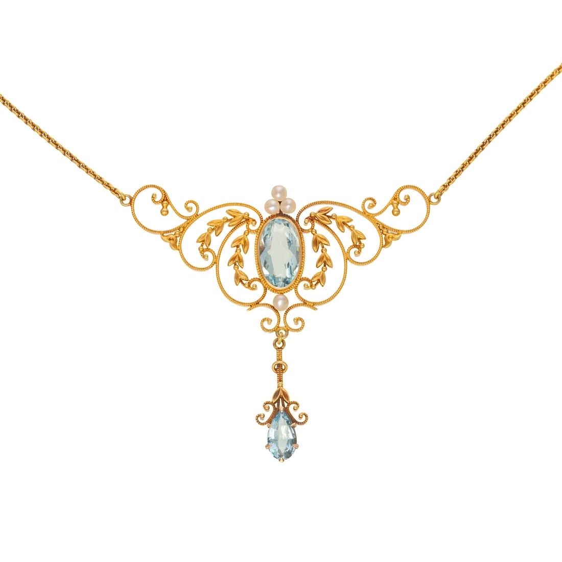 An Art Nouveau Aquamarine & Seed Pearl Drop Necklace in 14K: c. 1890s, 14K yellow gold necklace featuring an oval shaped aquamarine measuring 12 x 7 mm bezel set in an open work foliate design with seed pearl and milgrain accents suspending a foliate and