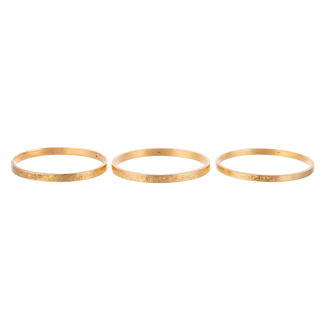 Three Art Nouveau Floral Engraved Bangles in 14K: 1) 14K yellow gold bangle with scrolling foliate engravings, 1914 date engraved on interior of bangle, 5.8 mm W, 2 1/2 in. interior Diam., 2) 14K yellow gold bangle by Sloan & Co. with scrolling